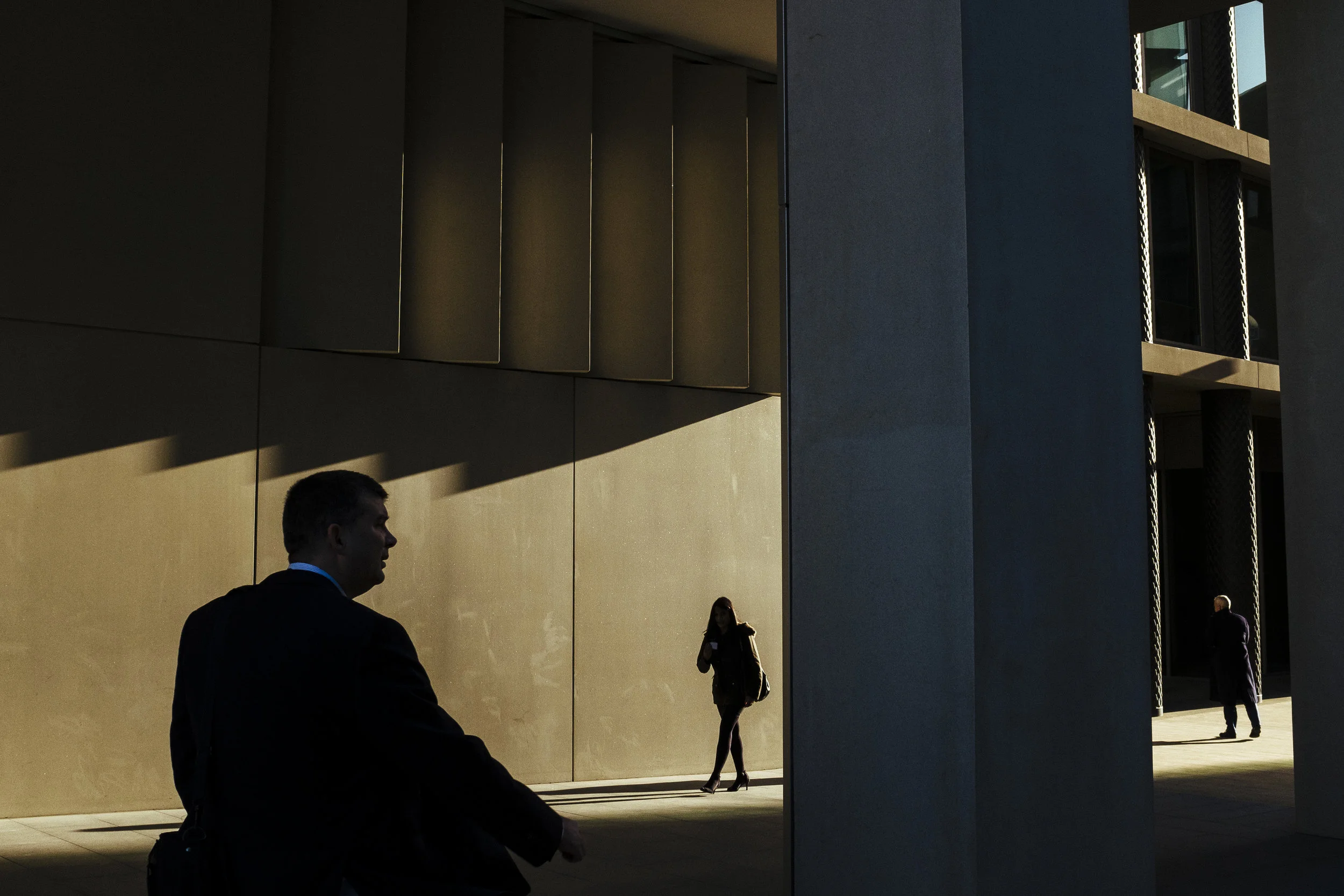 Pedestrians walk past recently opened office blocks near King's Cross railway station, London, Wednesday, Dec. 10, 2014.
