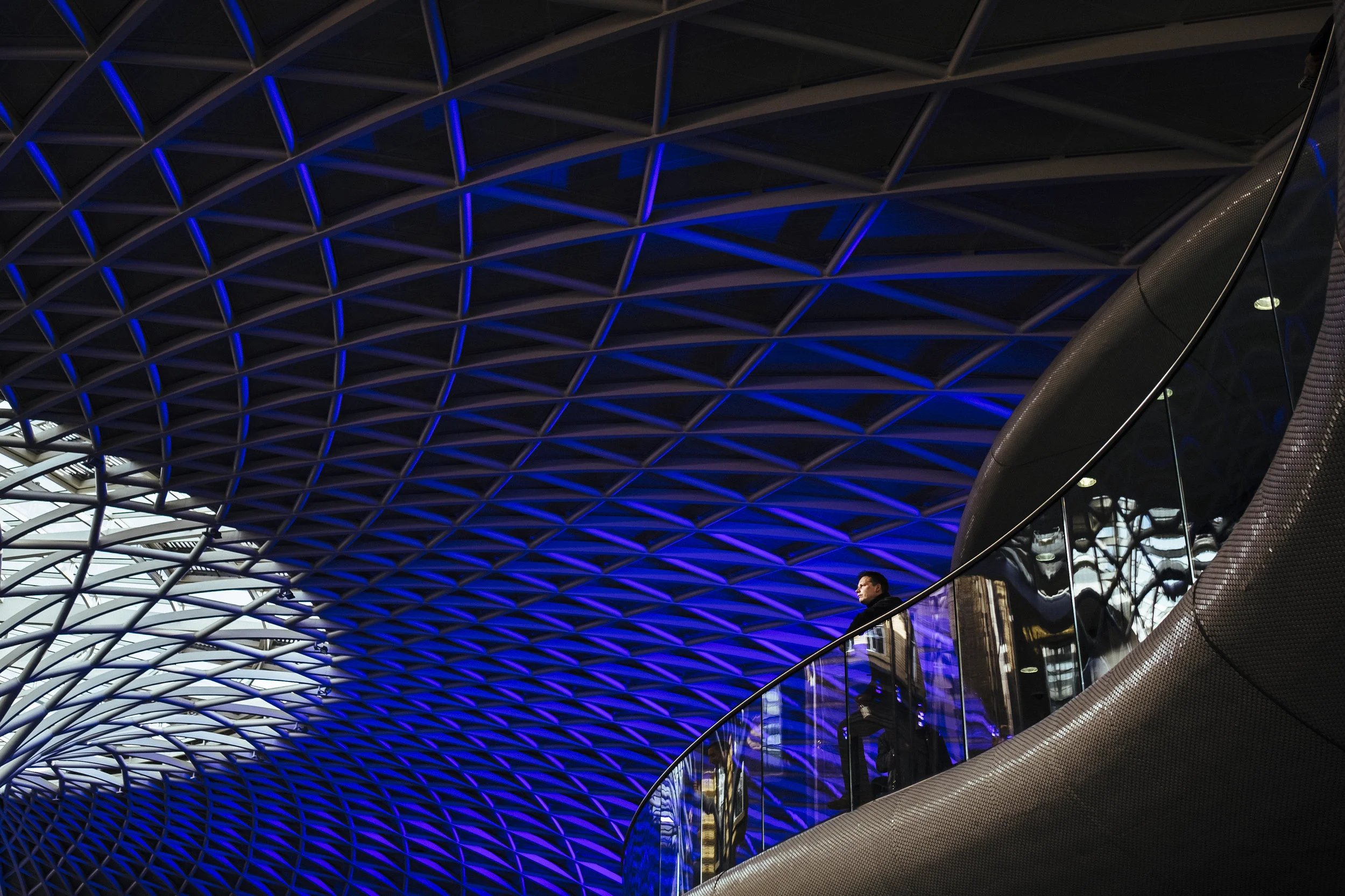 A person looks out from an elevated concourse at King's Cross railway station, London, Thursday, April 14, 2016.