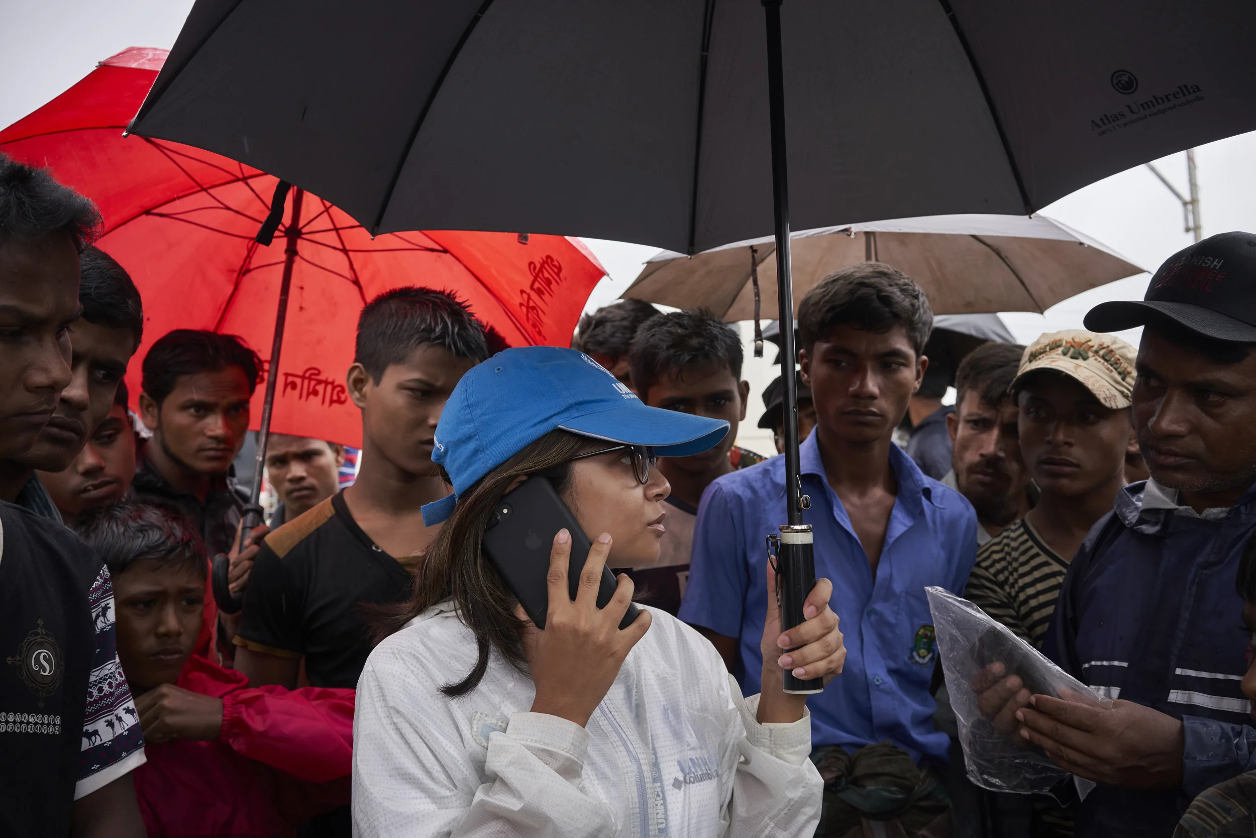 UNHCR Senior Field Associate Sarah Jabin, center, coordinates the relocation of 36 Rohingya refugee families, more than 150 people, from hazardous landslide and flood-prone zones to newly built shelters in an area that has been levelled, in Kutupalong Expansion Site for Rohingya refugees, Ukhia, Cox's Bazar District, Bangladesh.