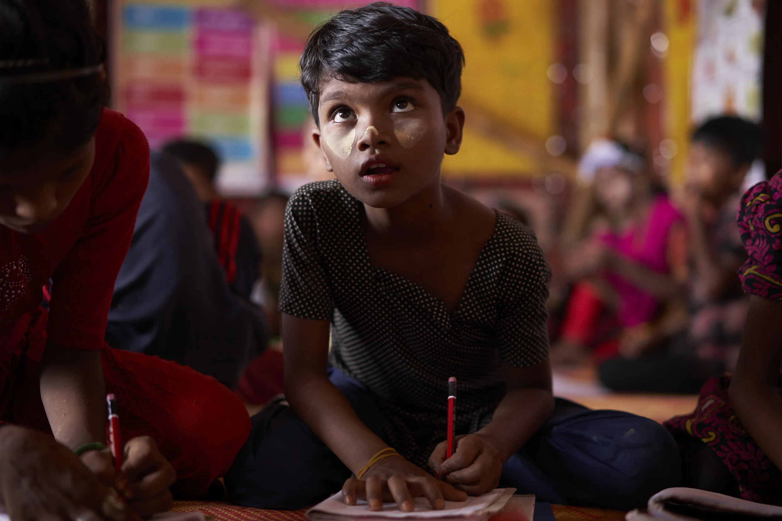 A Rohingya refugee student attends an English class at the Protivar Bikash 1 learning center in Camp 4, at the Kutupalong Expansion Site for Rohingya refugees, Ukhia, Cox's Bazar District, Bangladesh.