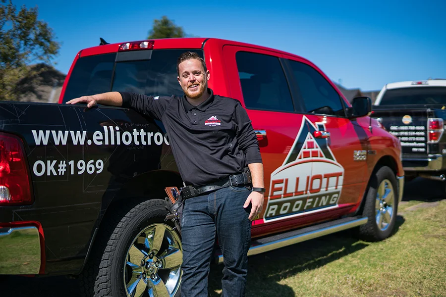 Elliott Roofing employee standing outside by his truck