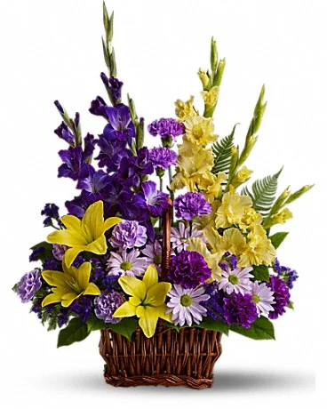 Basket Of Memories Honor rich remembrances of one dearly missed with a vivid mix of blooms that offer strength and comfort alike during a time of sorrow. Beautiful fresh flowers such as yellow asiatic lilies and gladioli contrast with purple carnations, statice and gladioli, plus lavender carnations and chrysanthemums in a rectangular basket with handle. Buy Now>>