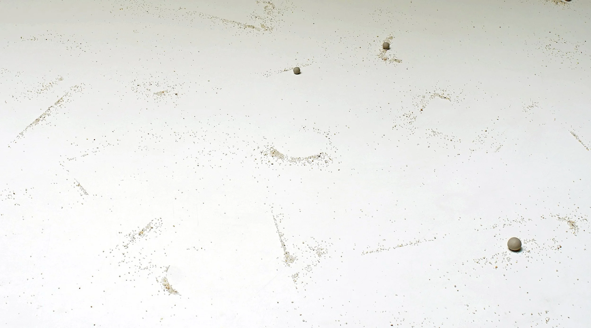 Mizzonk's Tracing Probablities is aSand and clay installation, capturing the fleeting nature of thought as shifting grains and clay imprints.