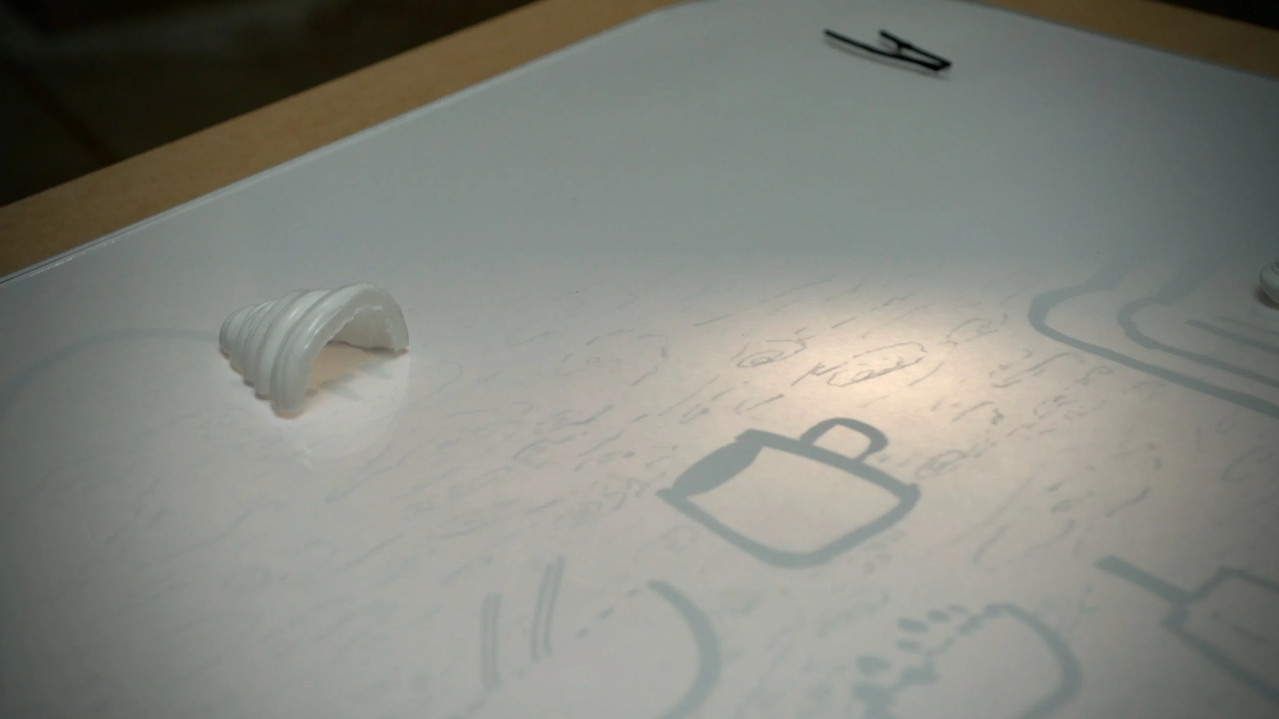 The childhood table from Mizzonk's H O M E ≠ H•O•M•E (Home but Not Home), an automated installation. It is a table that contains distant memories that fade upon a mental switch. When switched off, it is a table of a curious inquirer. The title invite