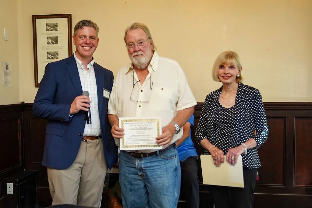 Dr. Tim Vail receives the Best of Show award from Jeremy Tessmer and Diane Waterhouse