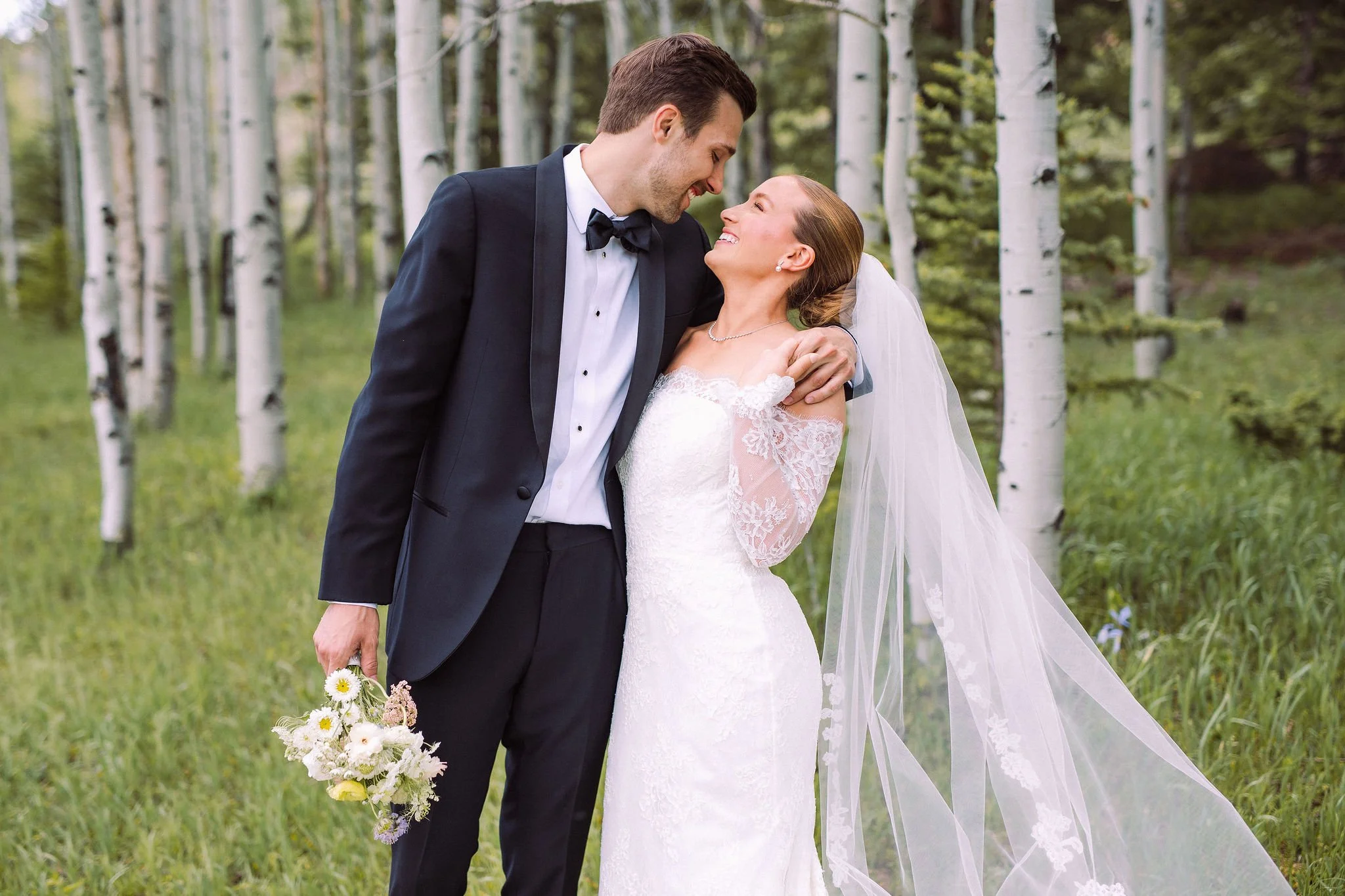 Bride and groom in aspen forest