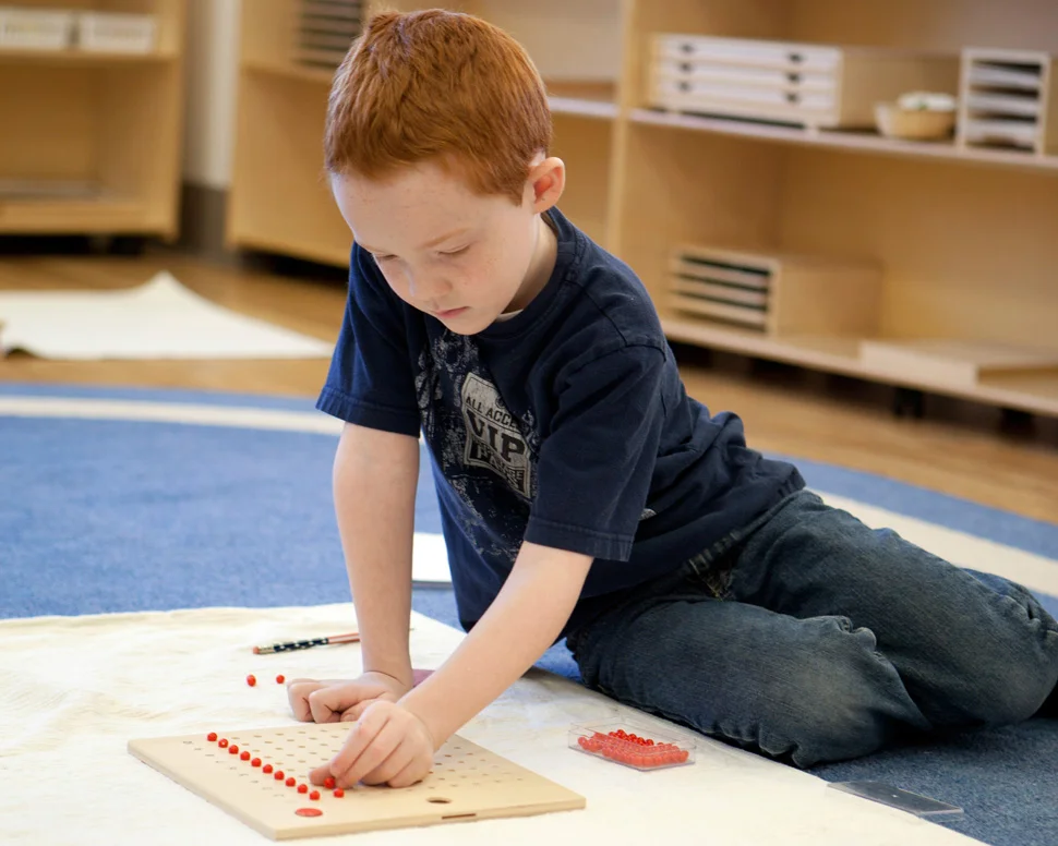 elementary boy engaged on floor.jpeg