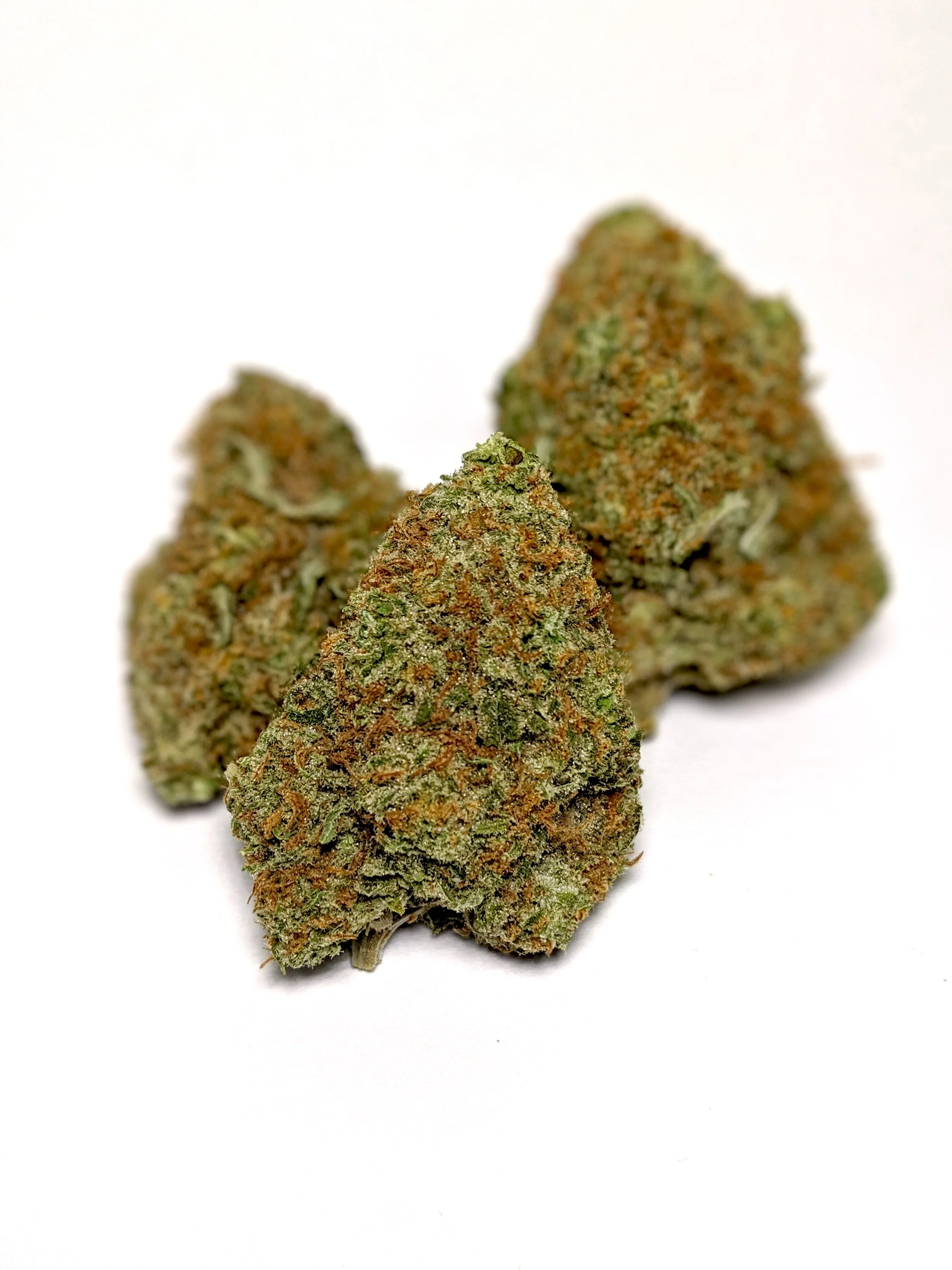 Platinum OG - Indica 1/4- $65 1/2-$110 OZ-$200 Platinum OG is just as precious as the metal it’s named after. With a THC content regularly topping 20%, this indica-dominant hybrid asserts itself as one of the “heaviest” strains around. Platinum OG is purported to stem from three strains: Master Kush , OG Kush , and a third unknown parent. Flowers are lime green and plump, with prominent orange hairs and a platinum coating thanks to the abundance of THC crystals. A brief, heady onset settles into a powerful physical sedation suitable for nighttime use and pain, stress, or anxiety relief, making this precious strain a robust healer.