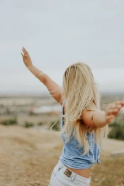 Woman with arms outstretched free spirit