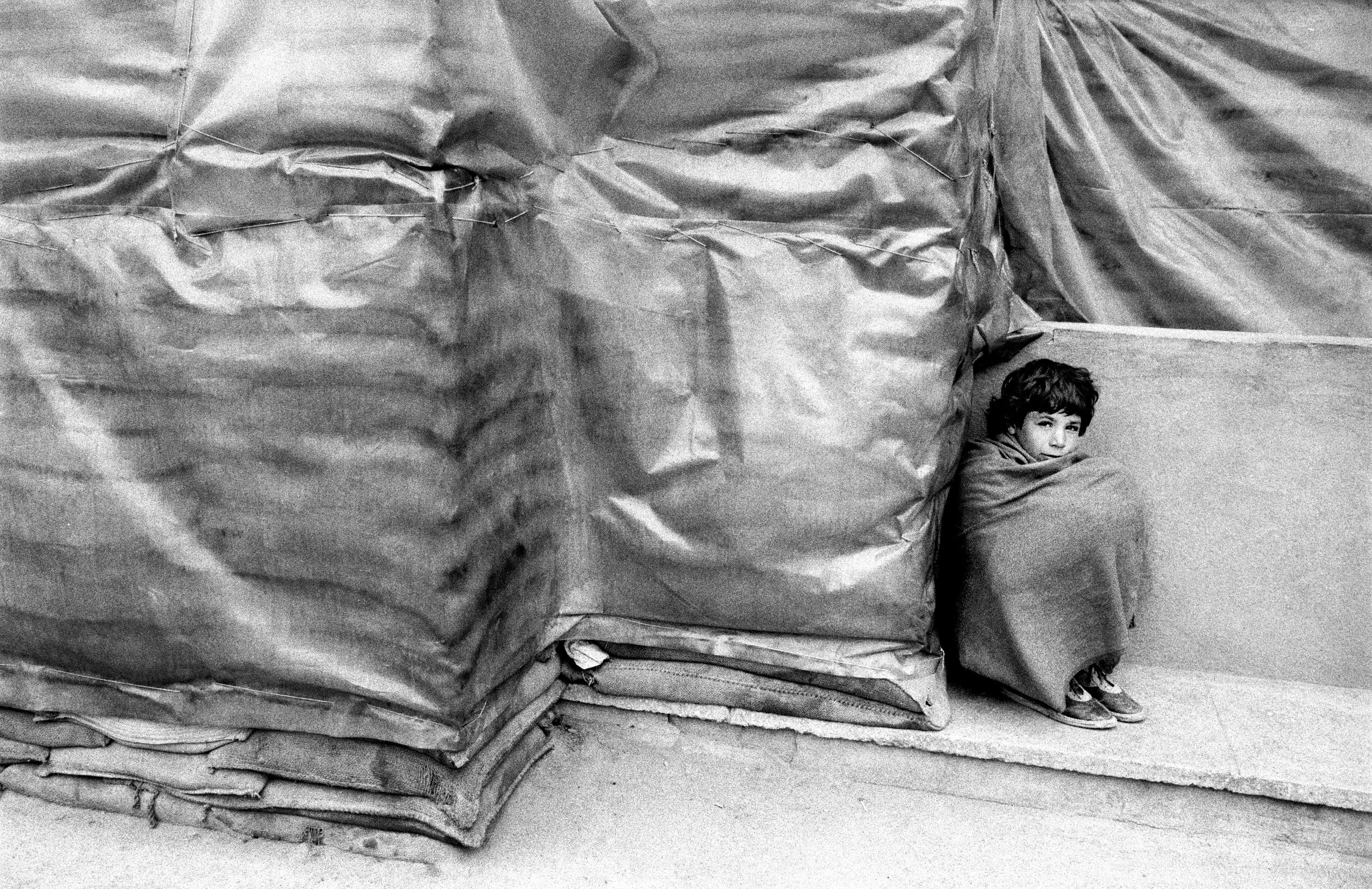 Afghan boy with sand bags (2).jpg