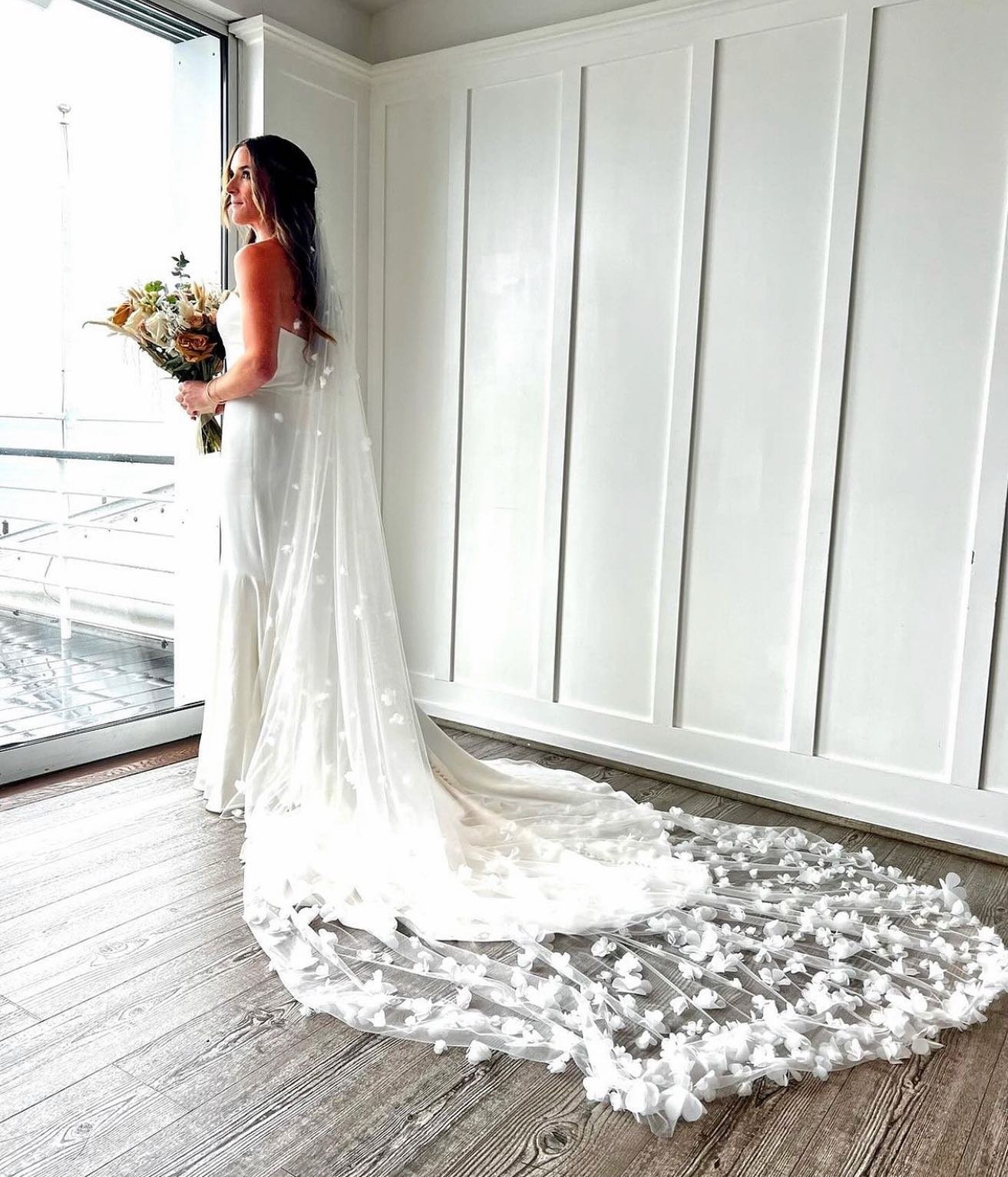 This veil! 😍 🤍🌸These delicate, appliqu&eacute; flowers over a sheer, cathedral length veil are the perfect way to elevate your wedding day look! It adds the perfect amount of detail + intricacies, but still understatedly elegant! 

Are you using a