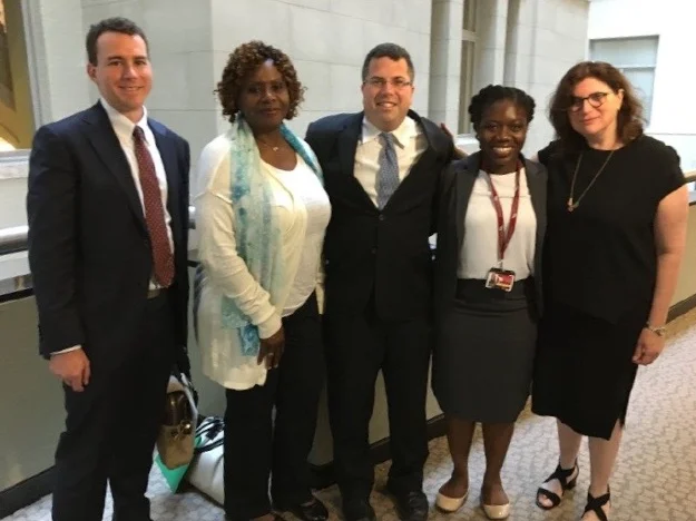 Ariel Levinson-Waldman (center) testifying with Tzedek DC.