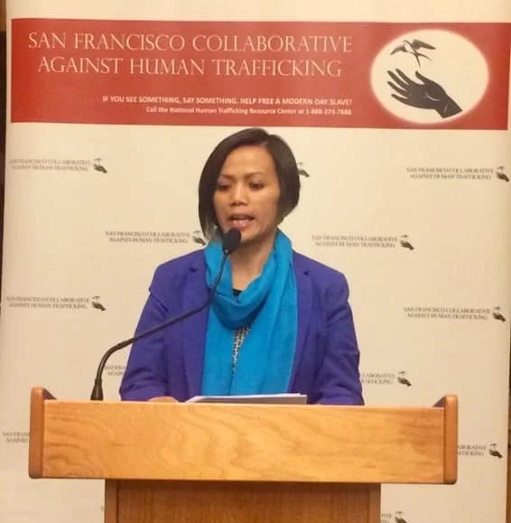 Ima Matul speaking at a conference in San Francisco.