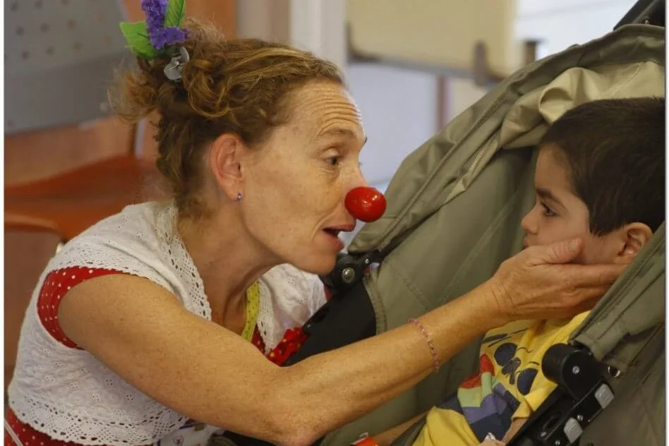 A Dream Doctor medical clown comforting a patient.