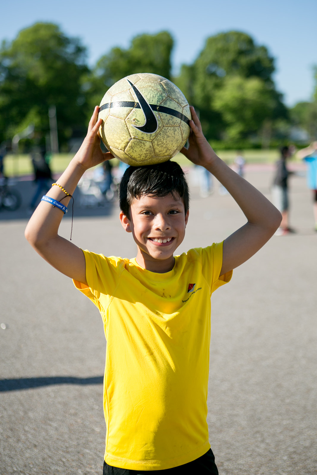 photo of young boy holding soccer ball