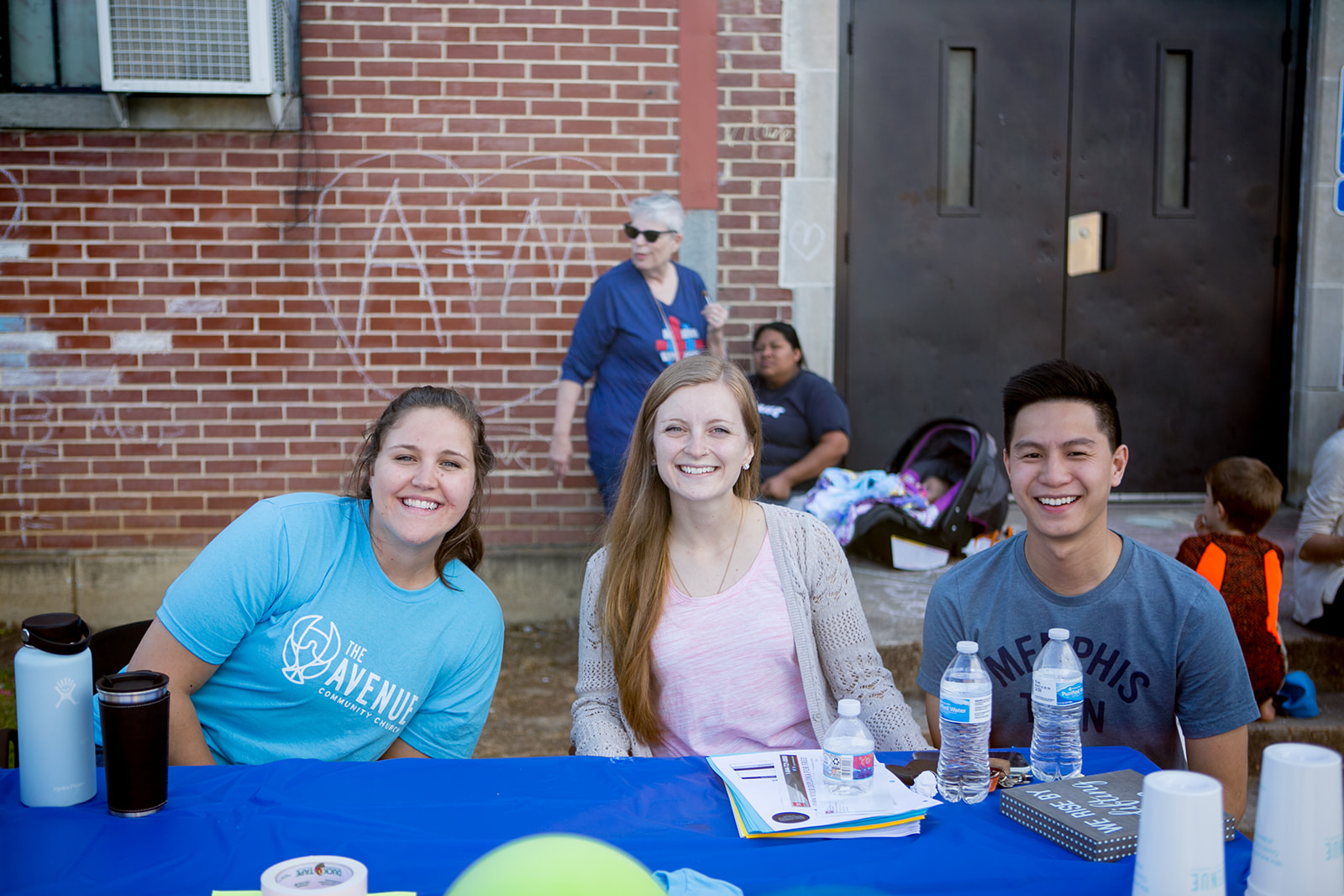 photo of three adults at a booth