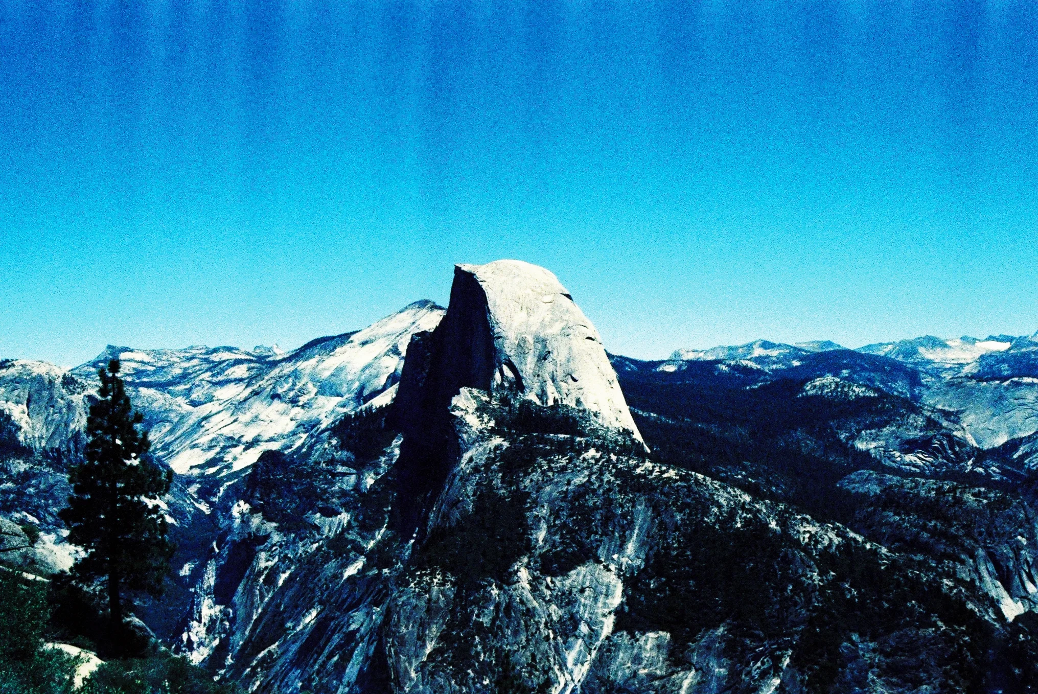  Pentax K1000.  Cross processed 35mm color film.  Distortion from accidental exposure to airport luggage x-ray.  Half Dome, Yosemite, California. 2015. 