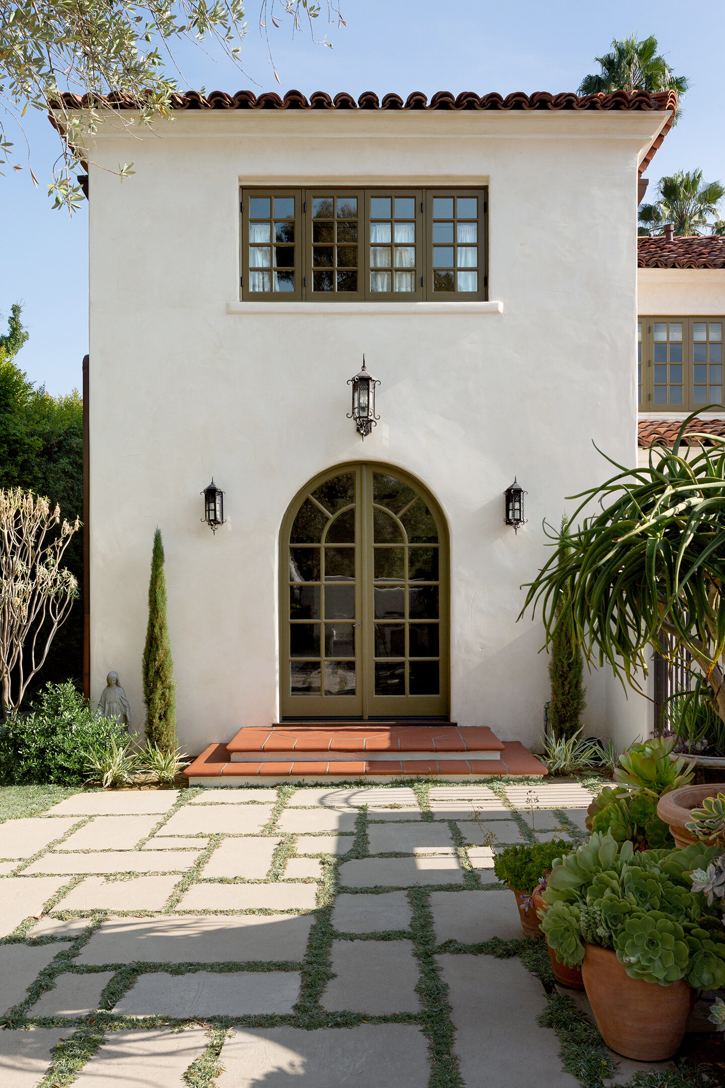 spanish-home-exterior-arched-doors-chelseadc.jpg