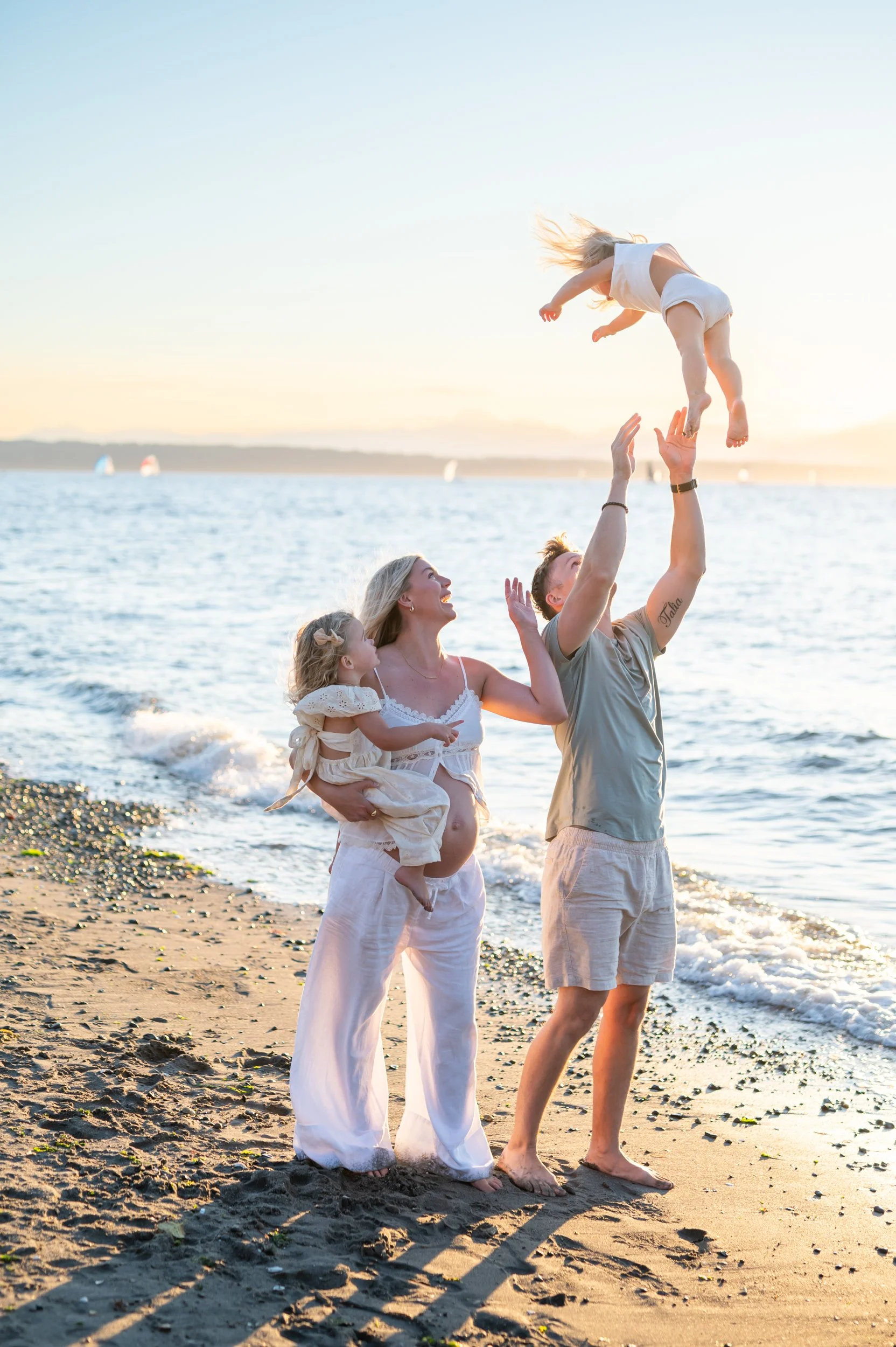 family of four on the beach having a sunset family session in seattle