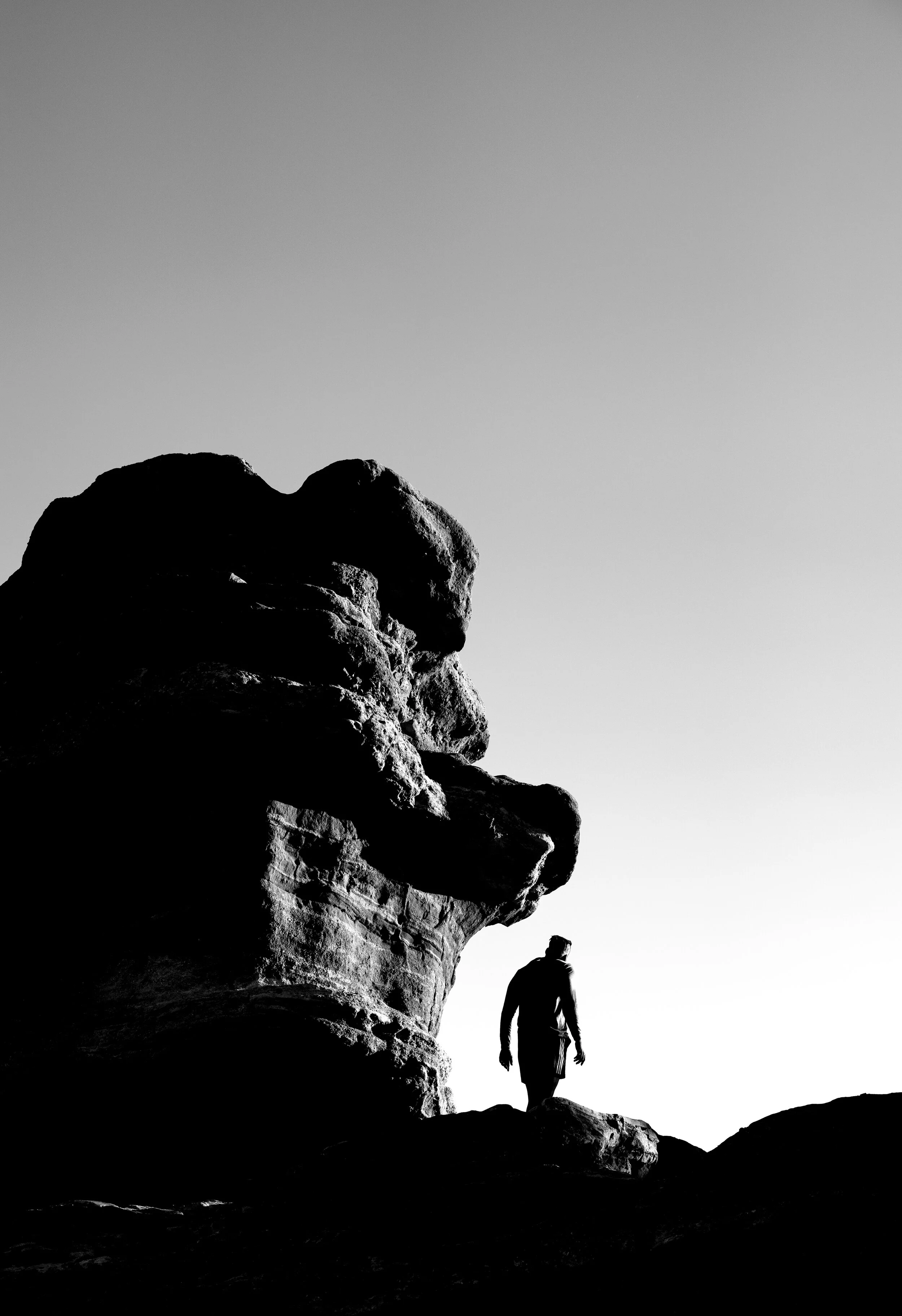 Balanced Rock with Silhouetted Man, Garden of the Gods, Colorado, 2019 / 24”x 35” / B+W Archival Metallic Paper Painted wood frame, museum glass