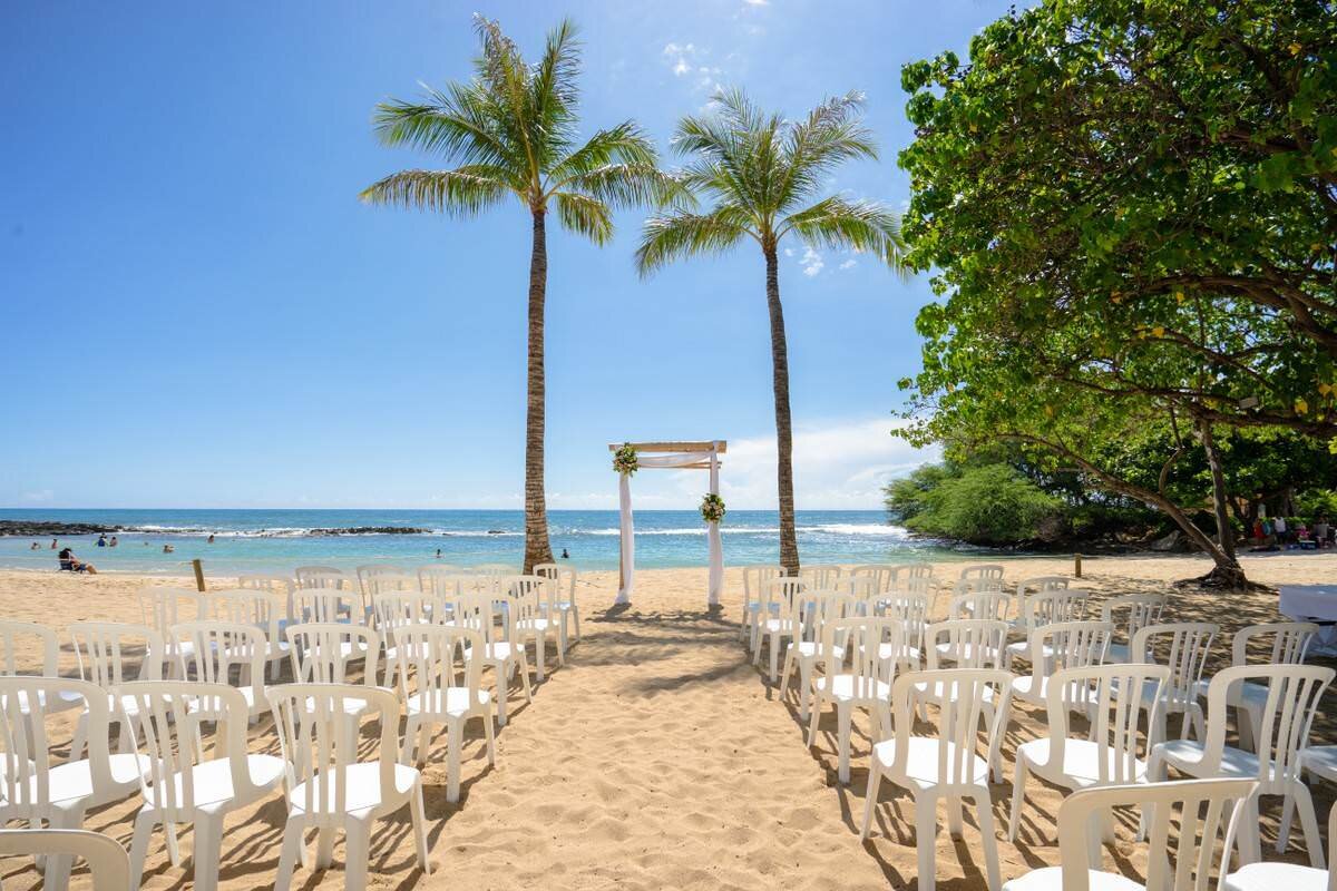 Wedding ceremony on the sand at Evening wedding reception at Paradise Cove Luau Hawaii