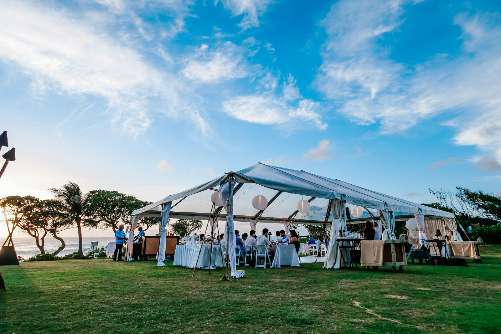 Oceanside wedding reception under white tent at Turtle Bay Resort North Shore Hawaii Wedding Venue