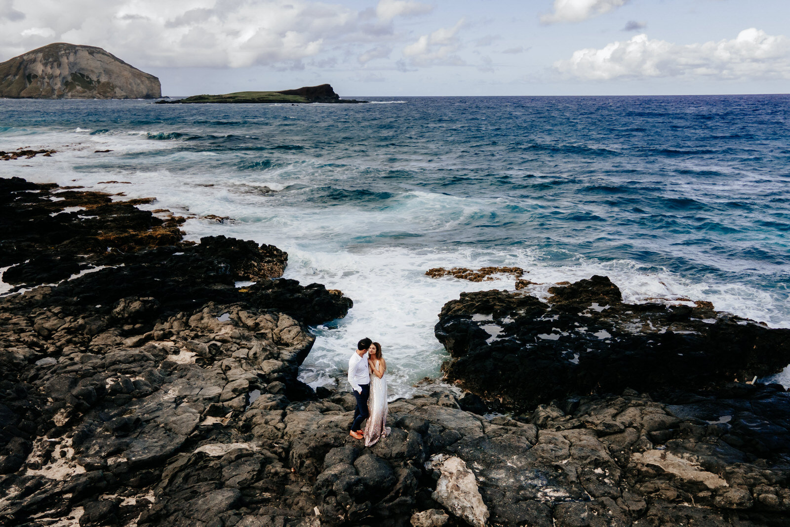 Couple on rocky beach aerial drone wedding portraits on Makapu'u Lookout Oahu Hawaii