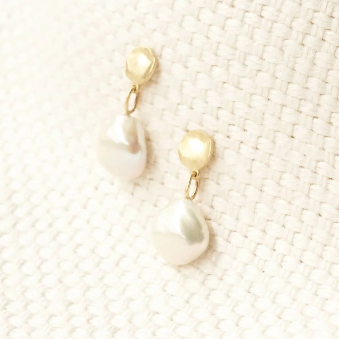 Custom beauty // Gold and pearl handcrafted organic disc drop earrings in satin finish.

A detail only noticed by it's owner, these delightful drop earrings were specifically designed to have each pearl sitting under the ear lobe, creating wonderful 