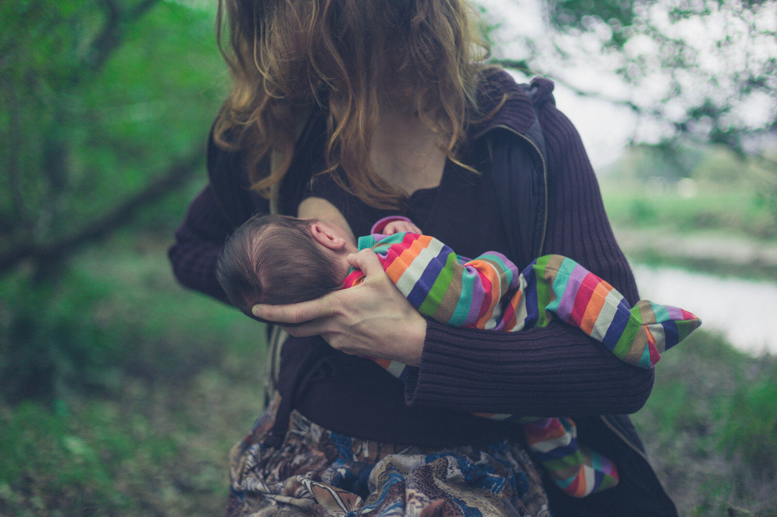 Canva - Mother Breastfeeding Baby in Forest.jpg