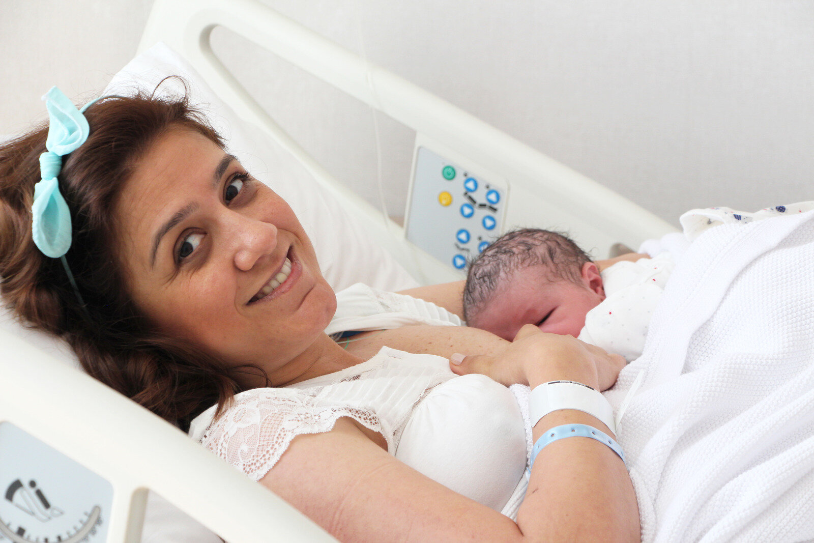 Canva - Mother breastfeeding her baby in hospital room.jpg