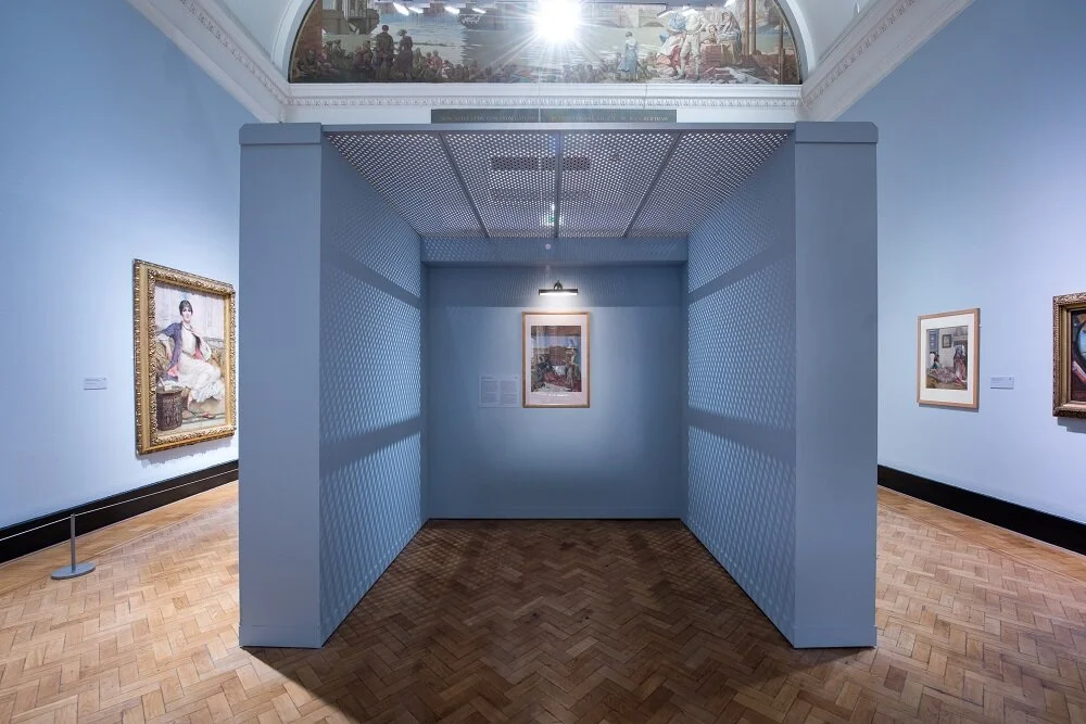  Image description: An install photo of the pale blue first room of ‘The Enchanted Interior’ exhibition, showing a small semi-enclosed space in the centre of the gallery housing a jewel-like watercolour by Victorian painter John Frederick Lewis, whic