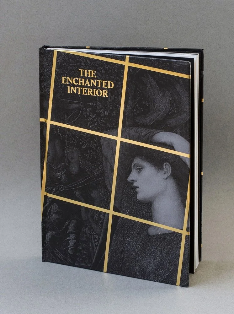  Image description: A hardback book whose cover shows a grayscale close-up of a Pre-Raphaelite painting of a woman in profile. A gold grid pattern is embossed over the image, creating the impression that the woman is behind a metal enclosure. In the 