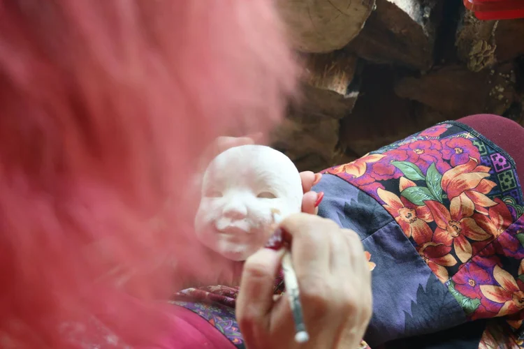 Miroslava painting a doll head