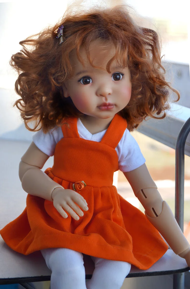Meadowdoll with red curls in an orange dress