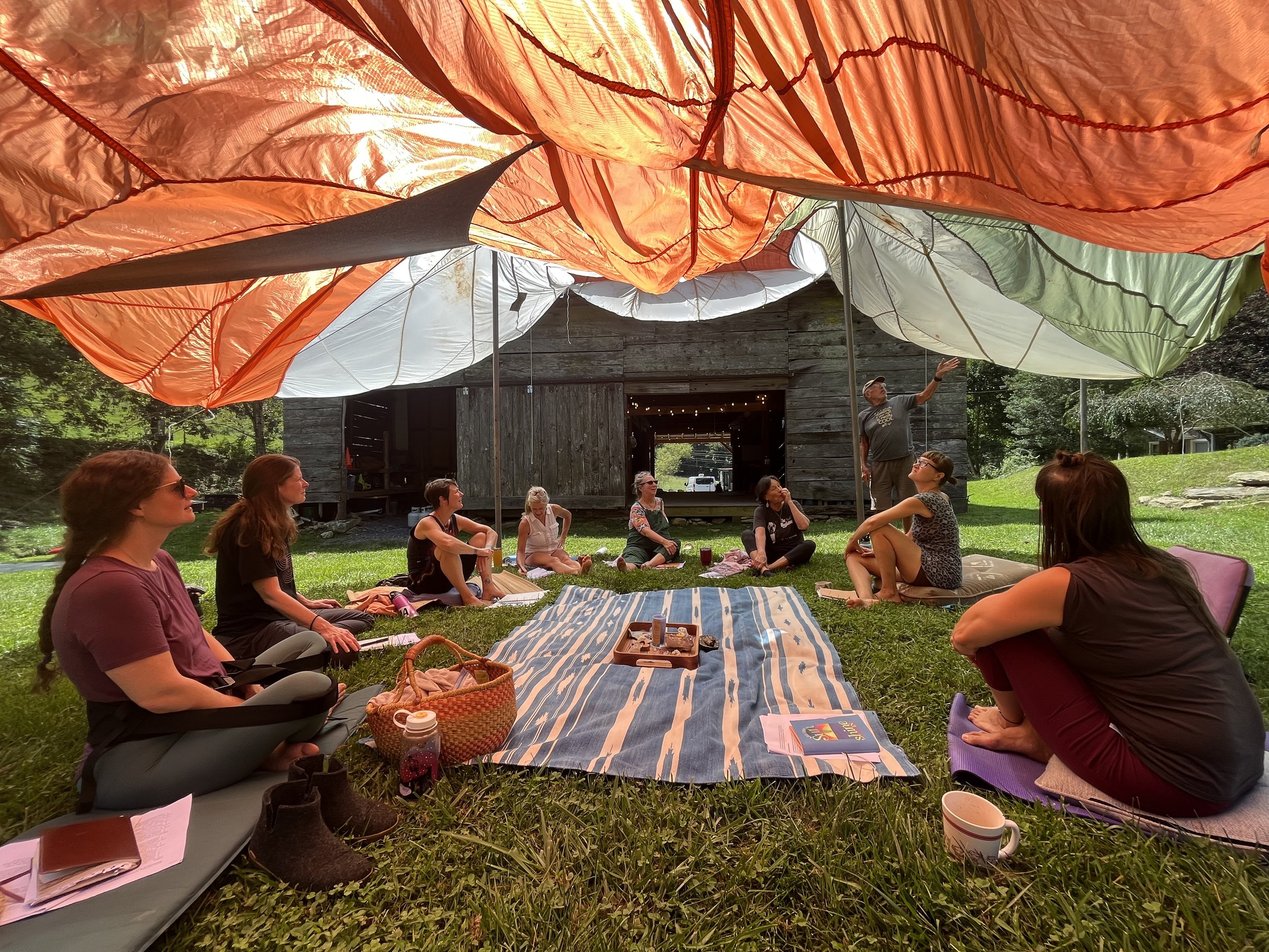 Women's circle under tarp.jpg