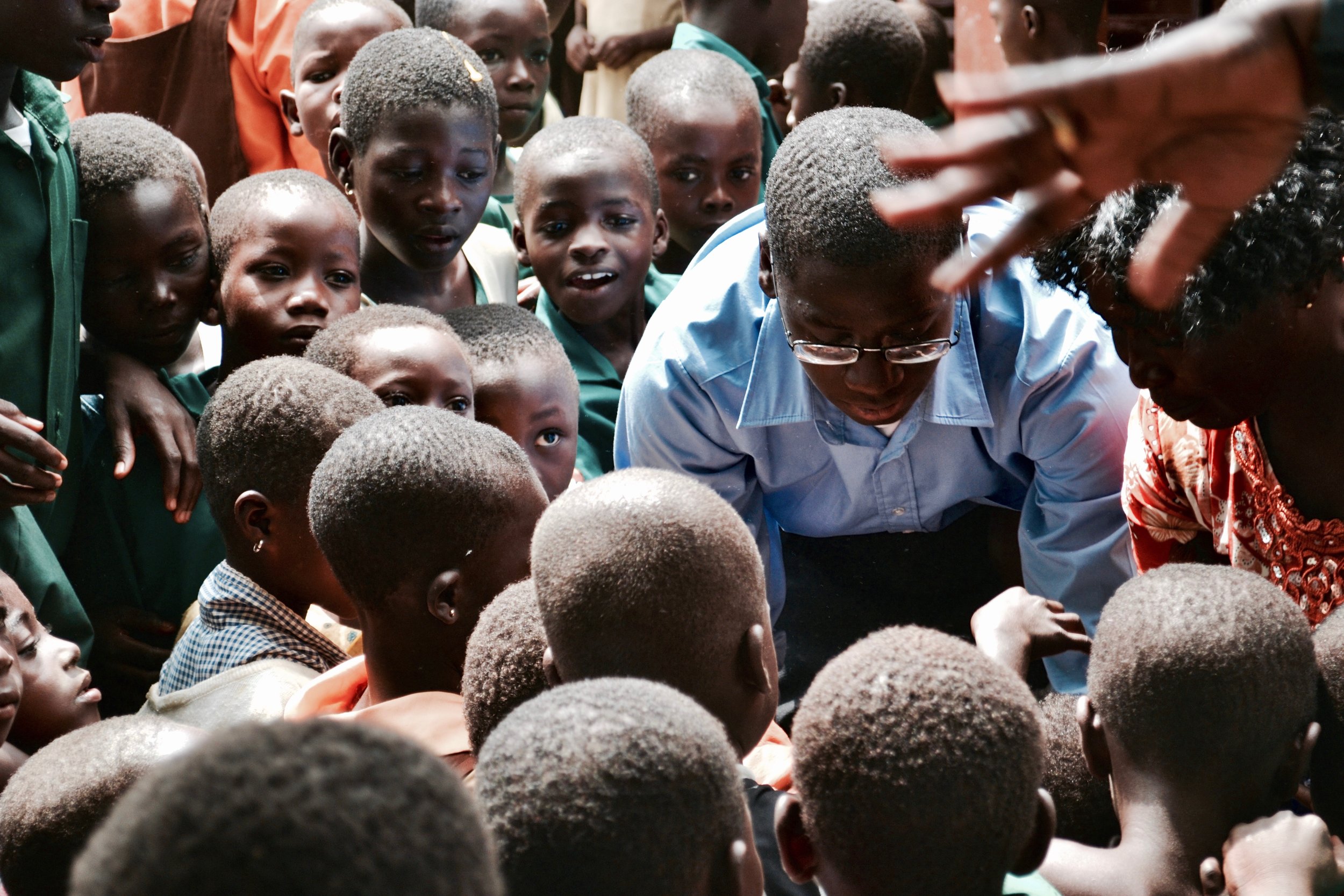  Student volunteers from the United States handing out stuffed animals to excited kids 