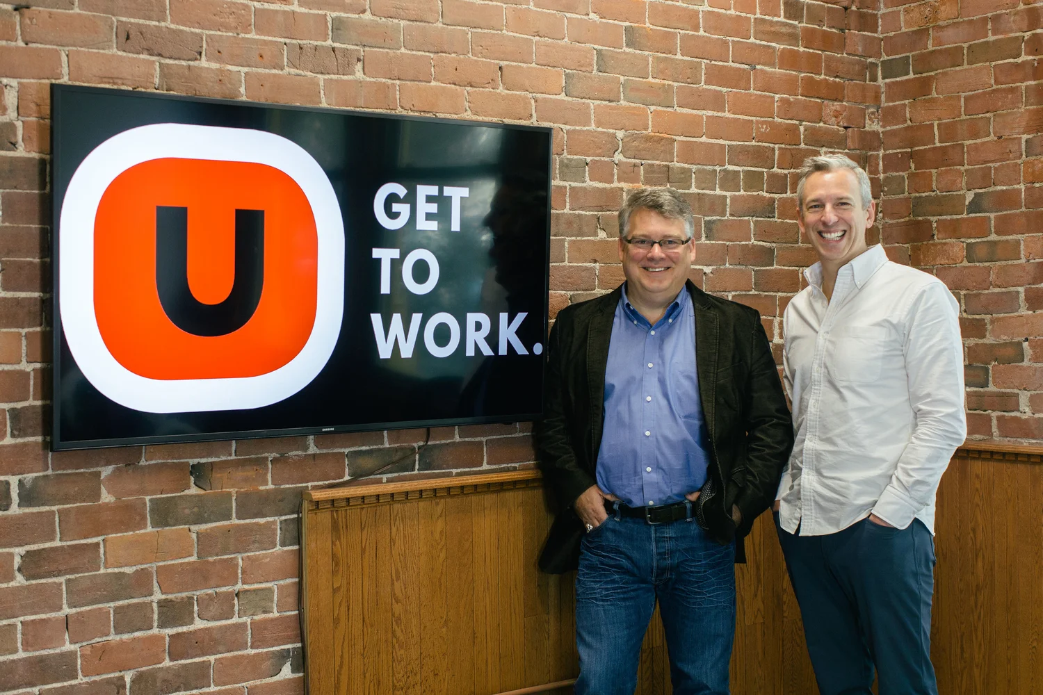 USTATION founders Glen Hicks and Jeff Roach in front of the Get to Work sign