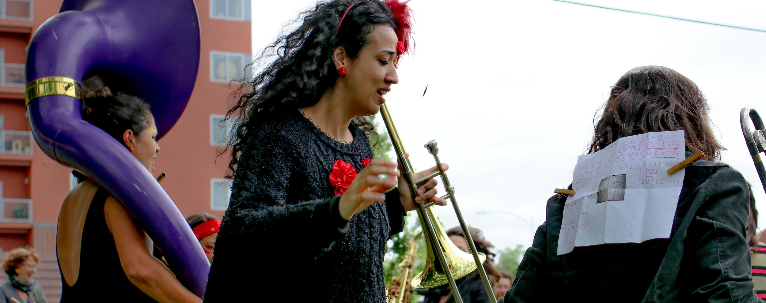  Band member sheet music pinned on her back to allow musician behind her to read the score. 