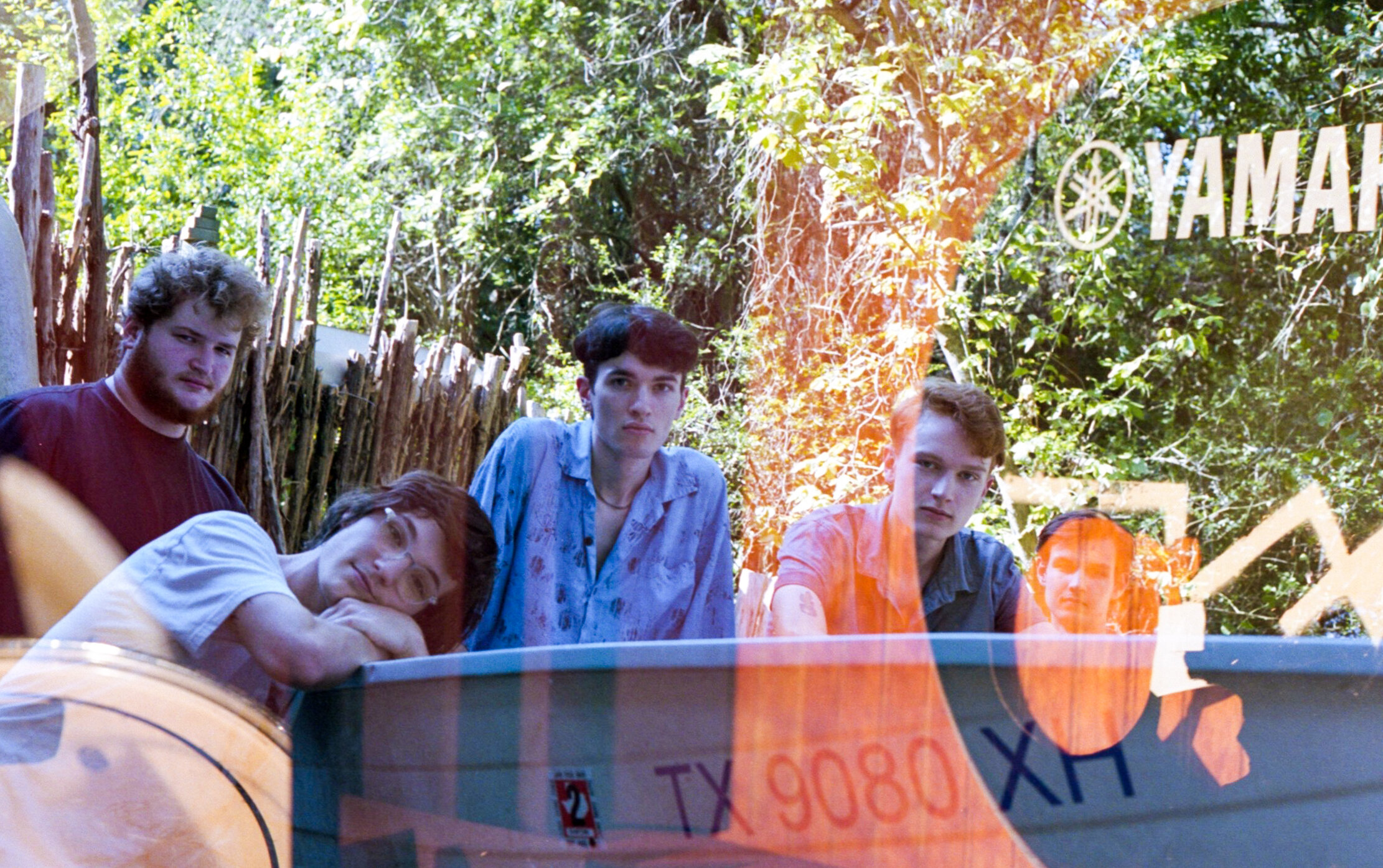  The band in their boat double exposed with bass drum face. 