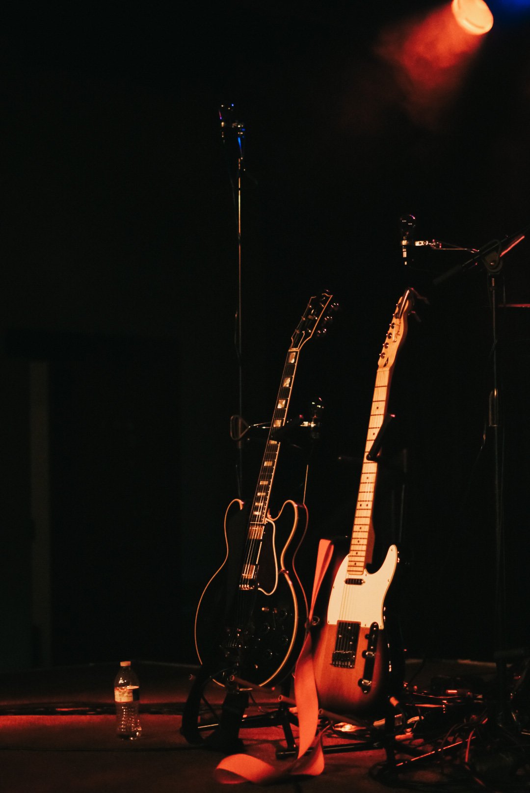  On-stage guitars prepared for the upcoming performance. 