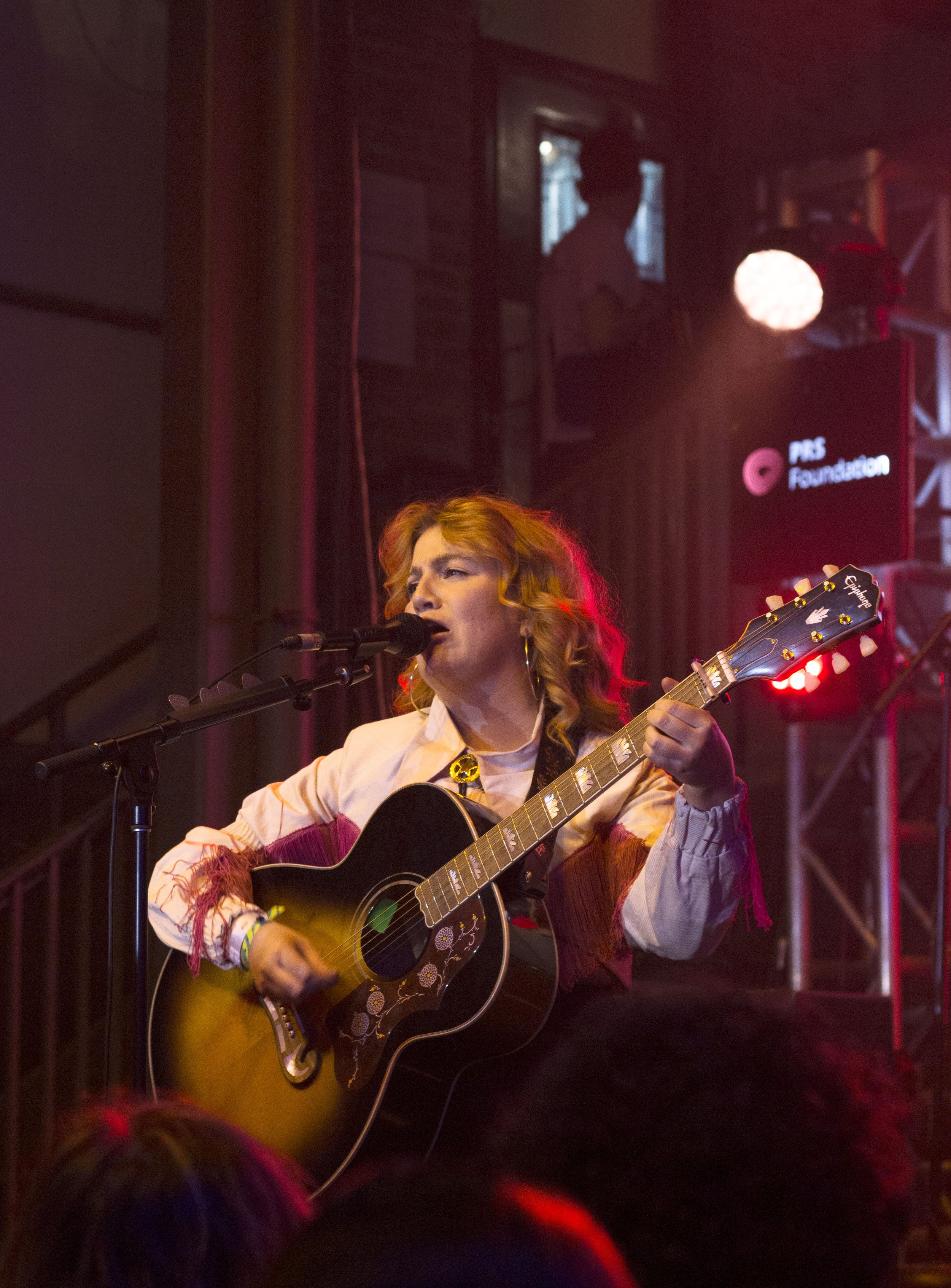  Irish pop star CMAT passionately sings to the crowd at Cedar Street Courtyard. 