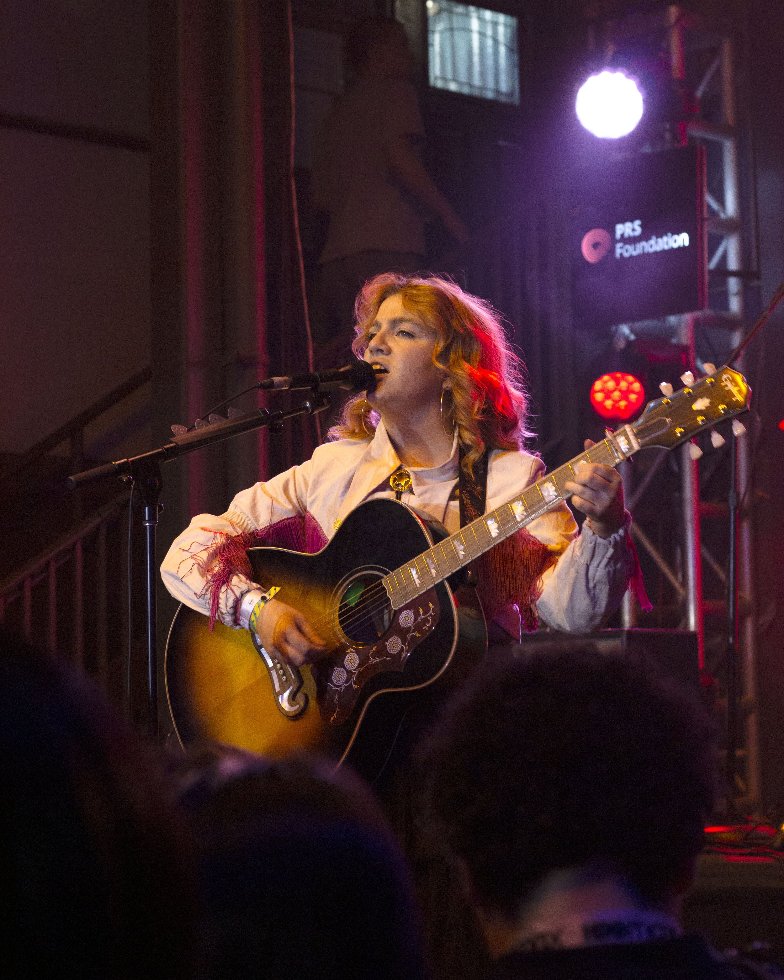  Irish pop star CMAT passionately sings to the crowd at Cedar Street Courtyard. 