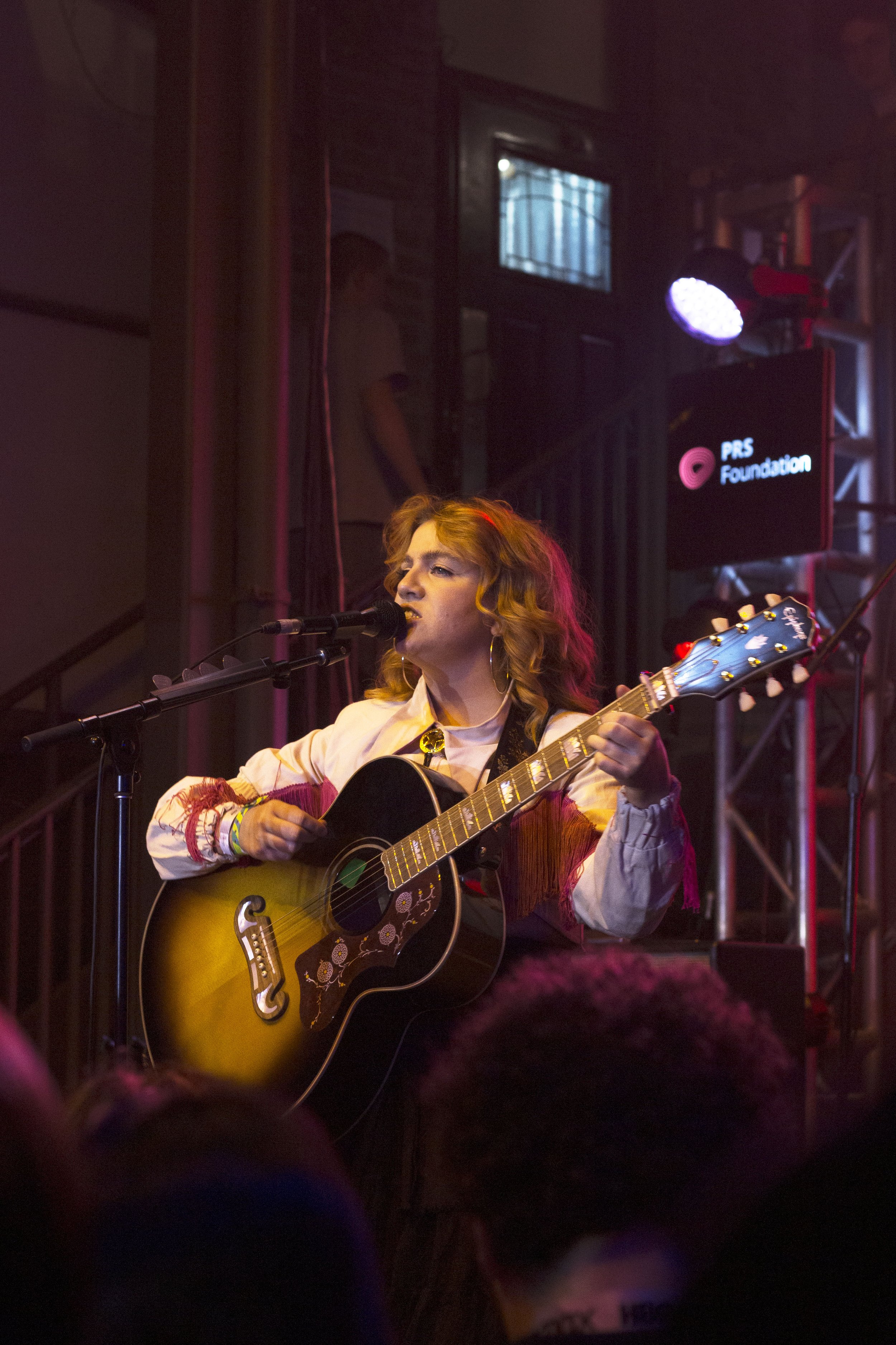  Irish pop star CMAT passionately sings to the crowd at Cedar Street Courtyard. 