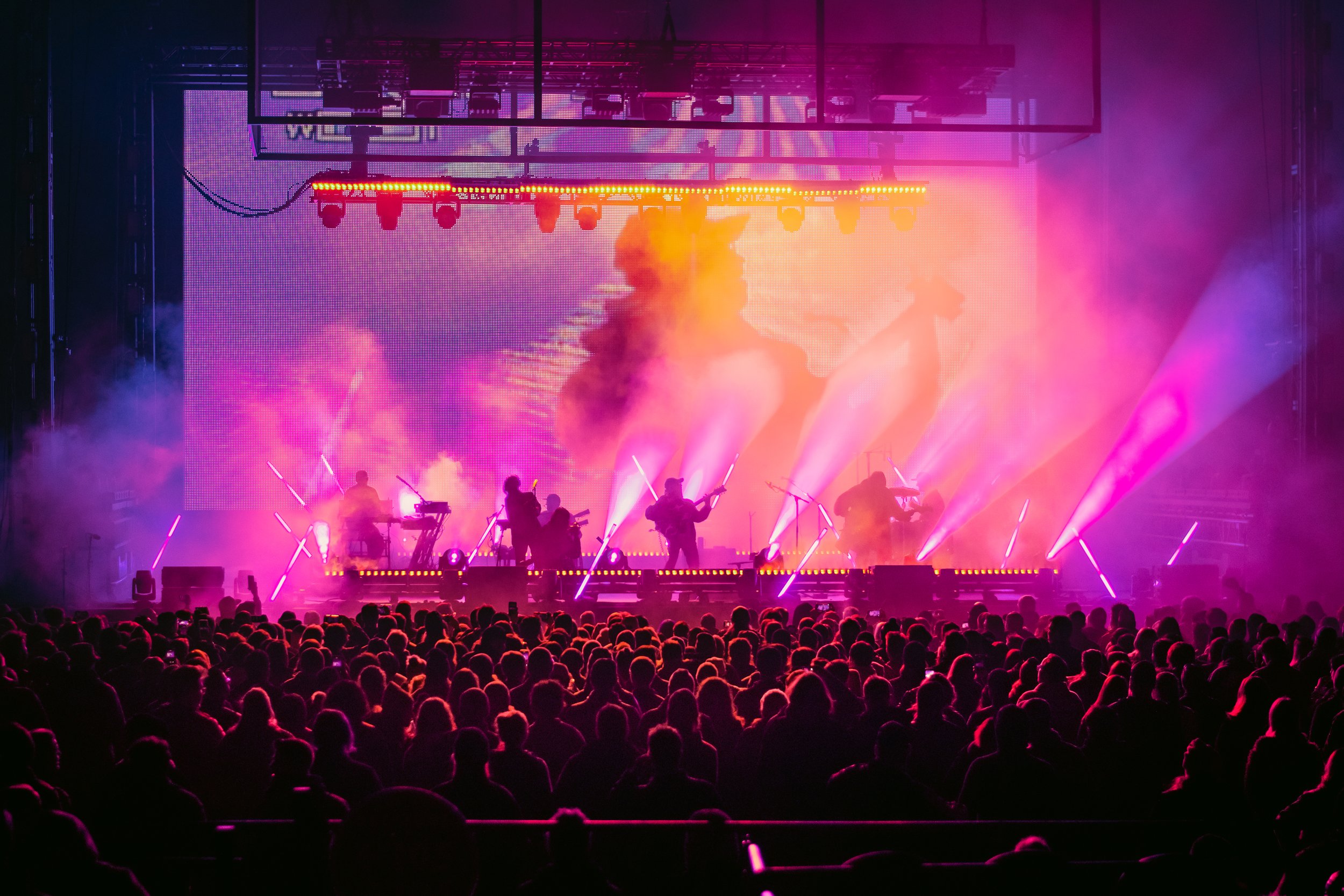  Portugal. The Man rocks the crowd with their energetic performance on a polychromatic stage. 
