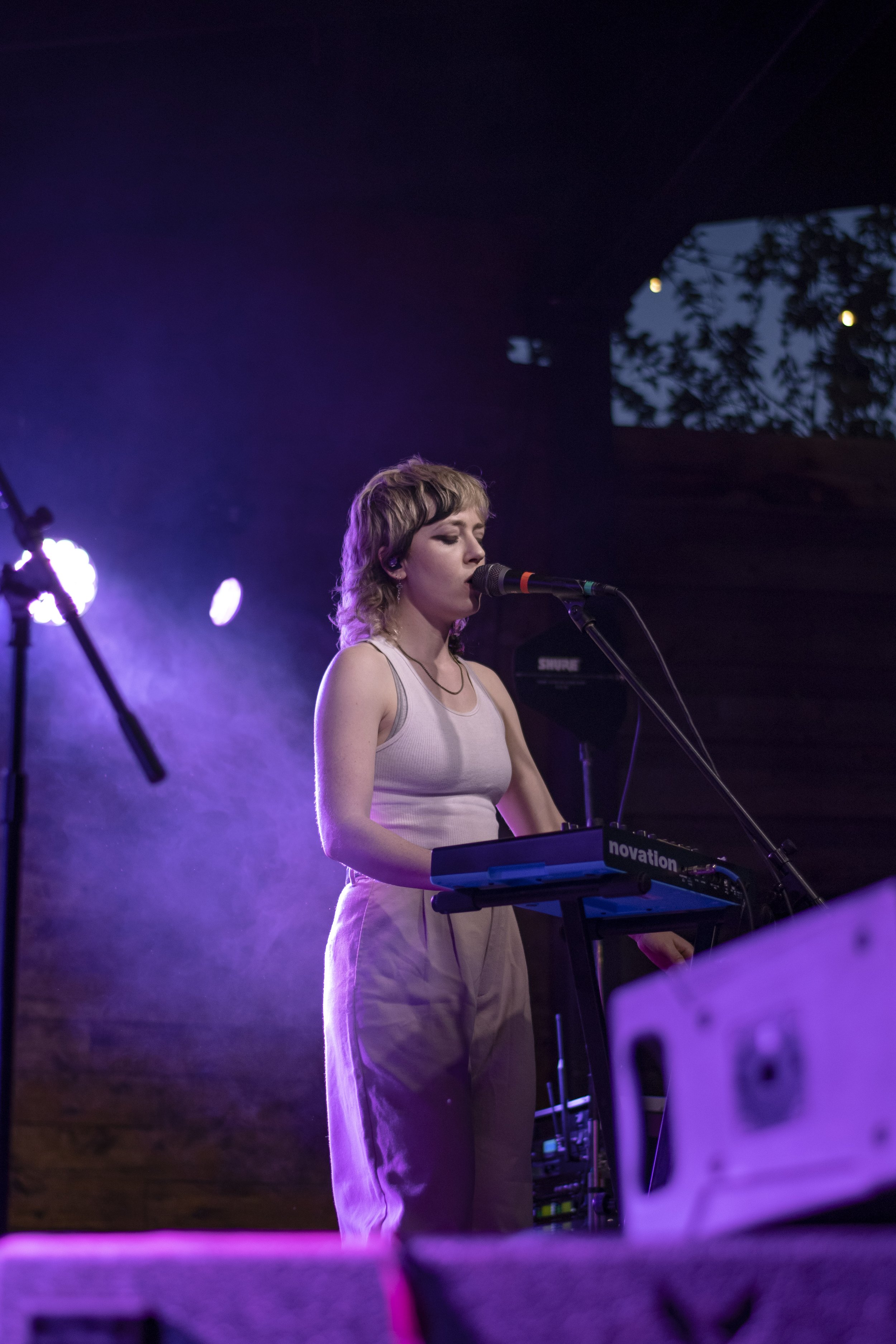  Brooke Dickson sings backup vocals while playing the keyboard. 