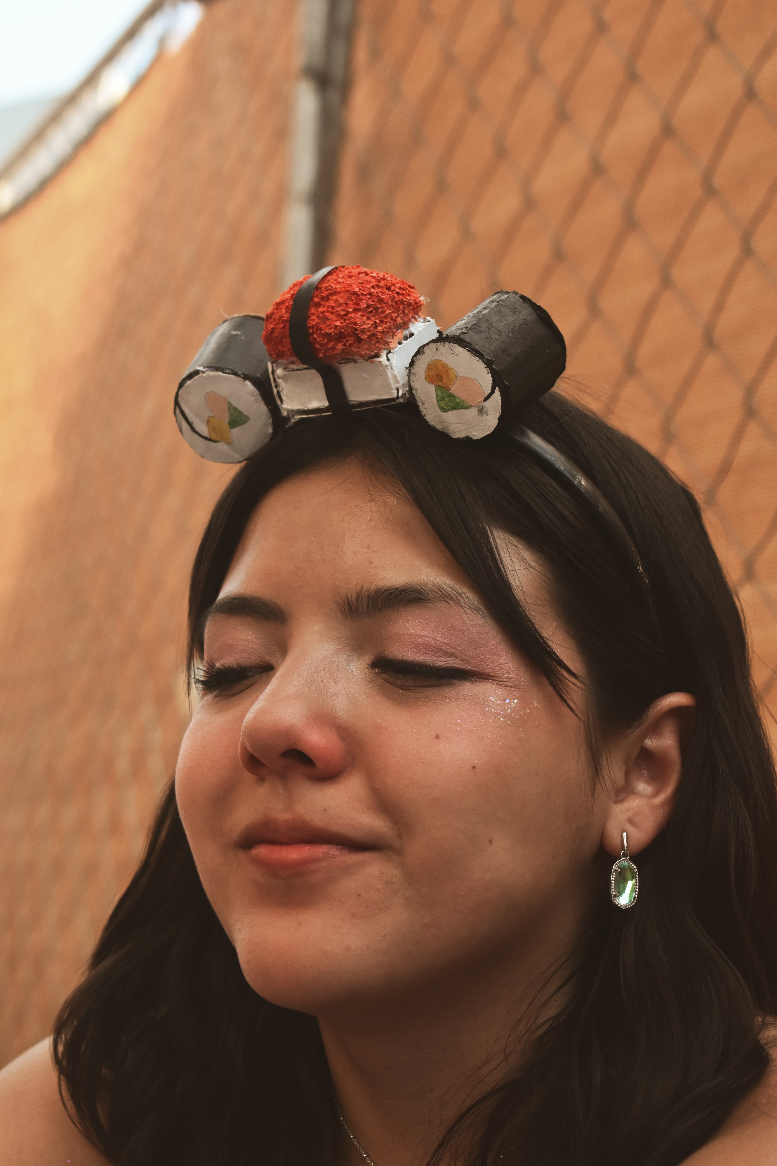  UT freshman Priscilla made a sushi themed headband out of cardboard the night before the show to mimic Styles’s song “Music For A Sushi Restaurant.” “This is my first concert ever … it’s kinda crazy, we’re literally so close to him,” she said. 