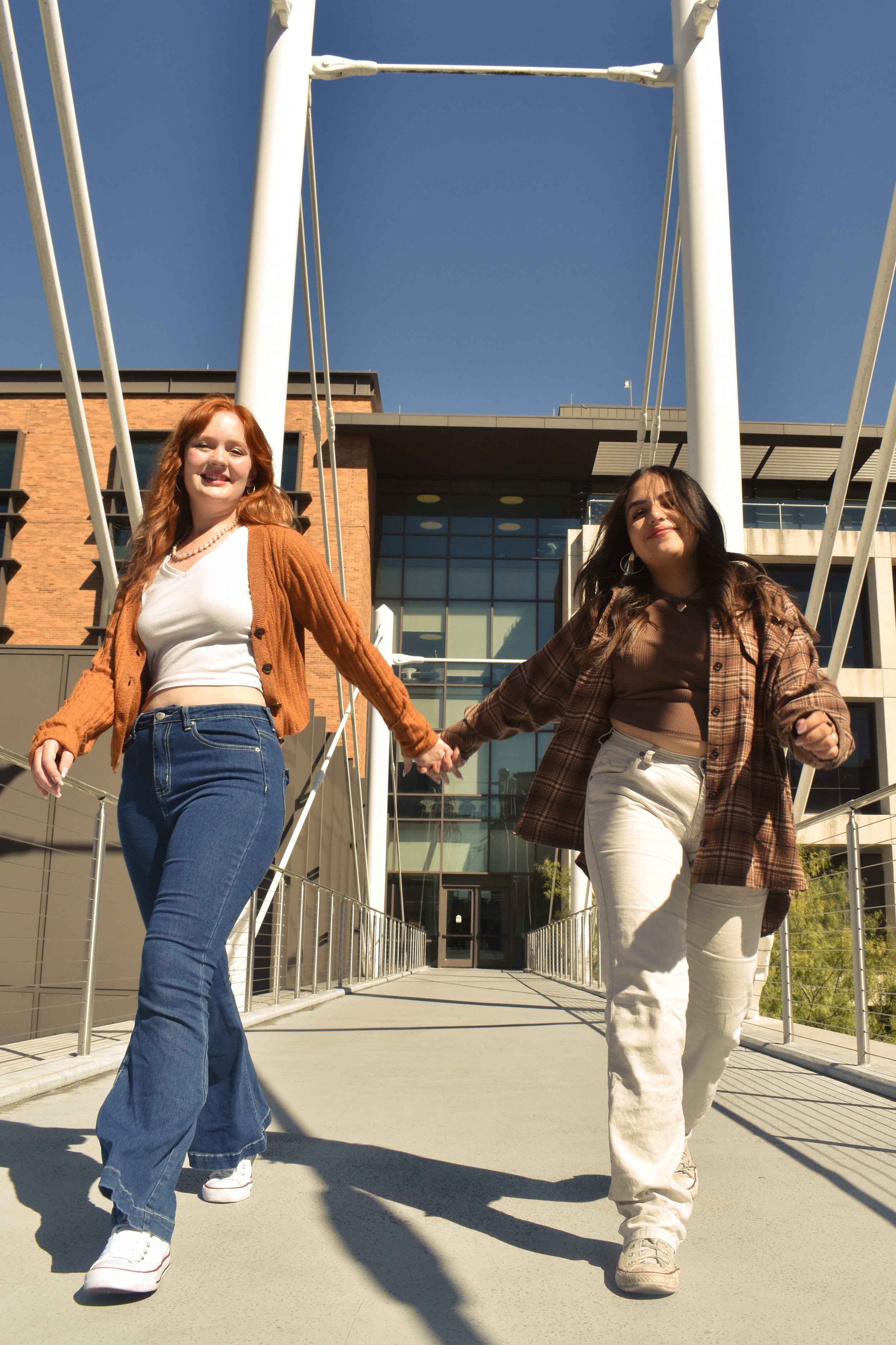   Fearless : Maya Richards (left) and Ana Martinez Villegas (right) skip down the Moody Bridge, reflecting the carefree energy of the  Fearless  album. 