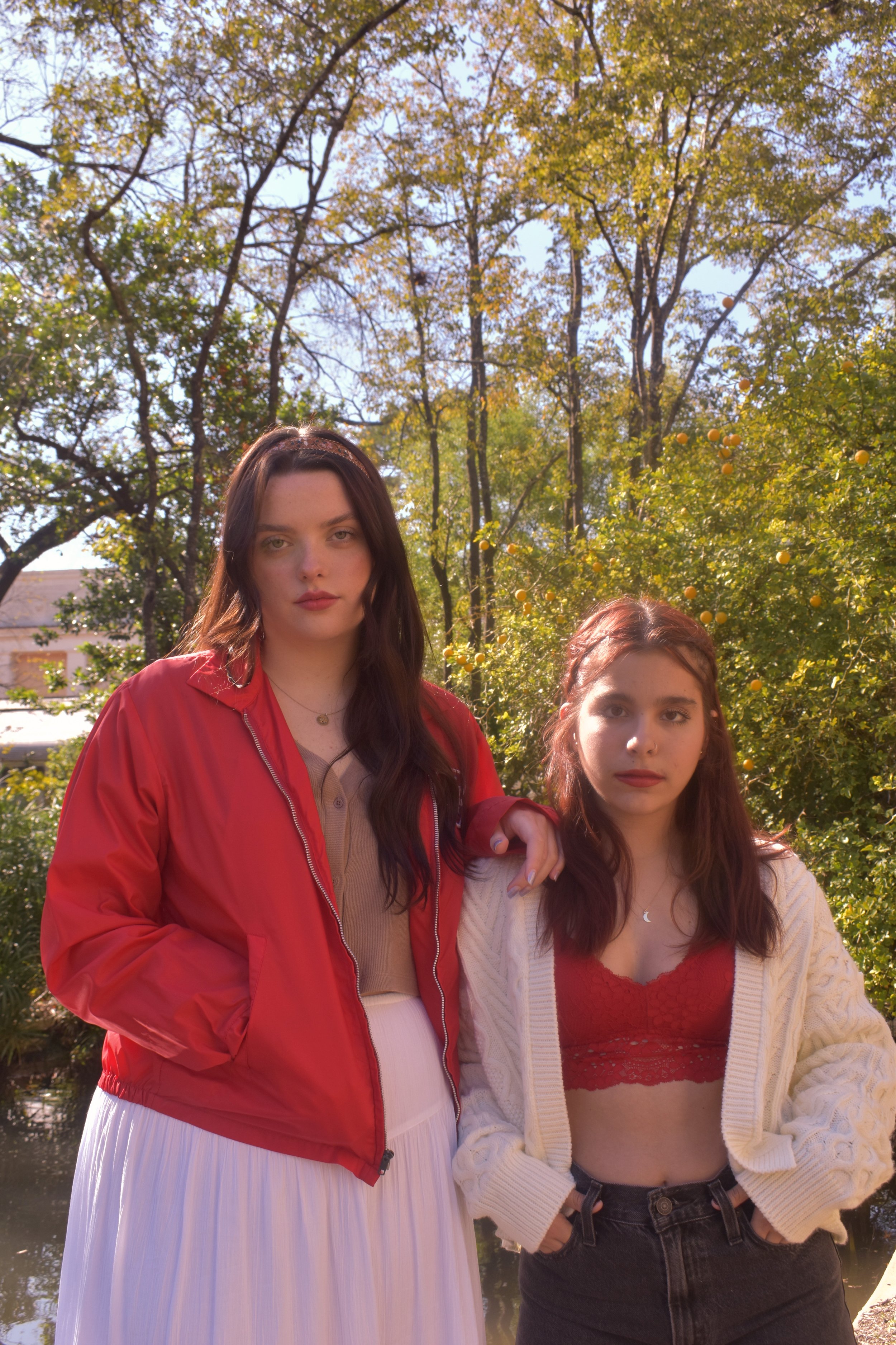   Red : Laina Paez (left) and Jules Murillo (right) pose contemplatively by the turtle pond. 