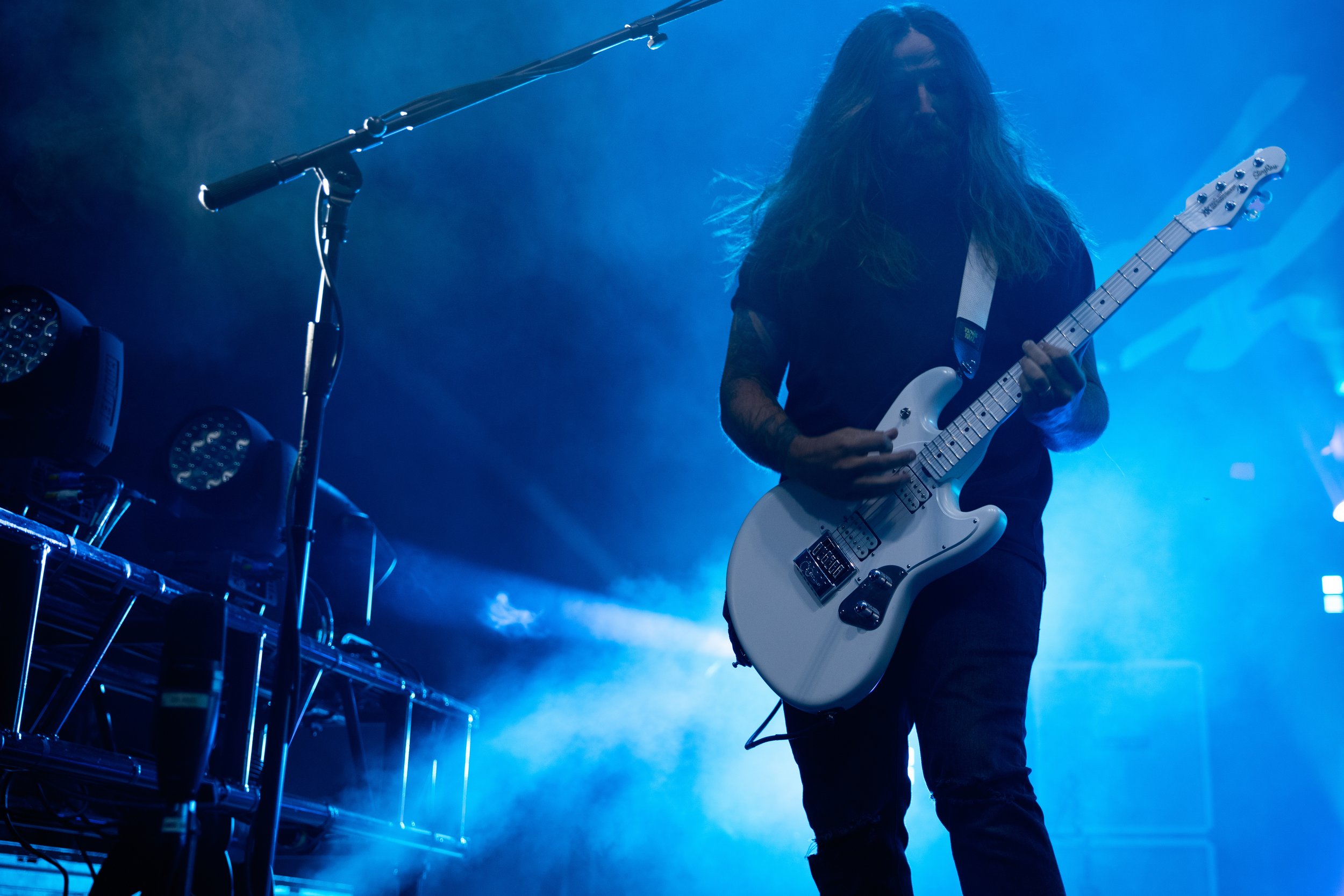  Guitarist Joey Bradford picks away at his guitar as the crowd grows even louder as a result of his riffs. 