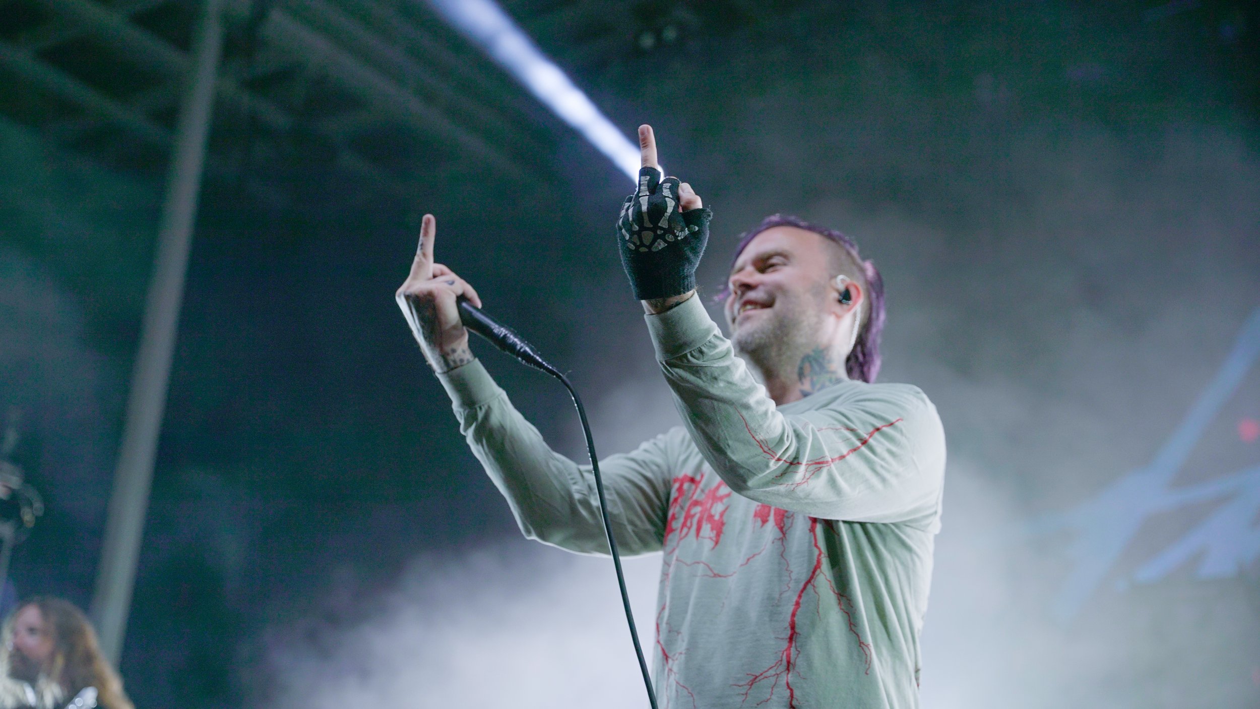  Frontman Bert McCracken takes a moment to get as close as he can to the audience and presents them a double middle finger, all with a smile on his face. 